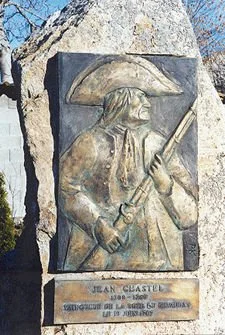 A bronze relief monument of Jean Chastel holding a musket, located in La Besseyre-Saint-Mary, France, honoring the man who killed the Beast of Gévaudan.