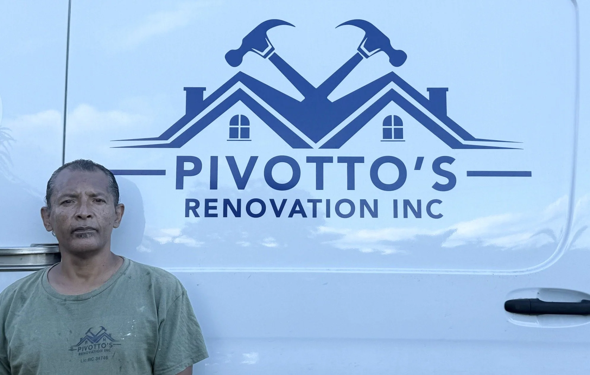 Man standing in front of a white van with logo and text for Pivotto's Renovation Inc, featuring house rooftops and crossed hammers.