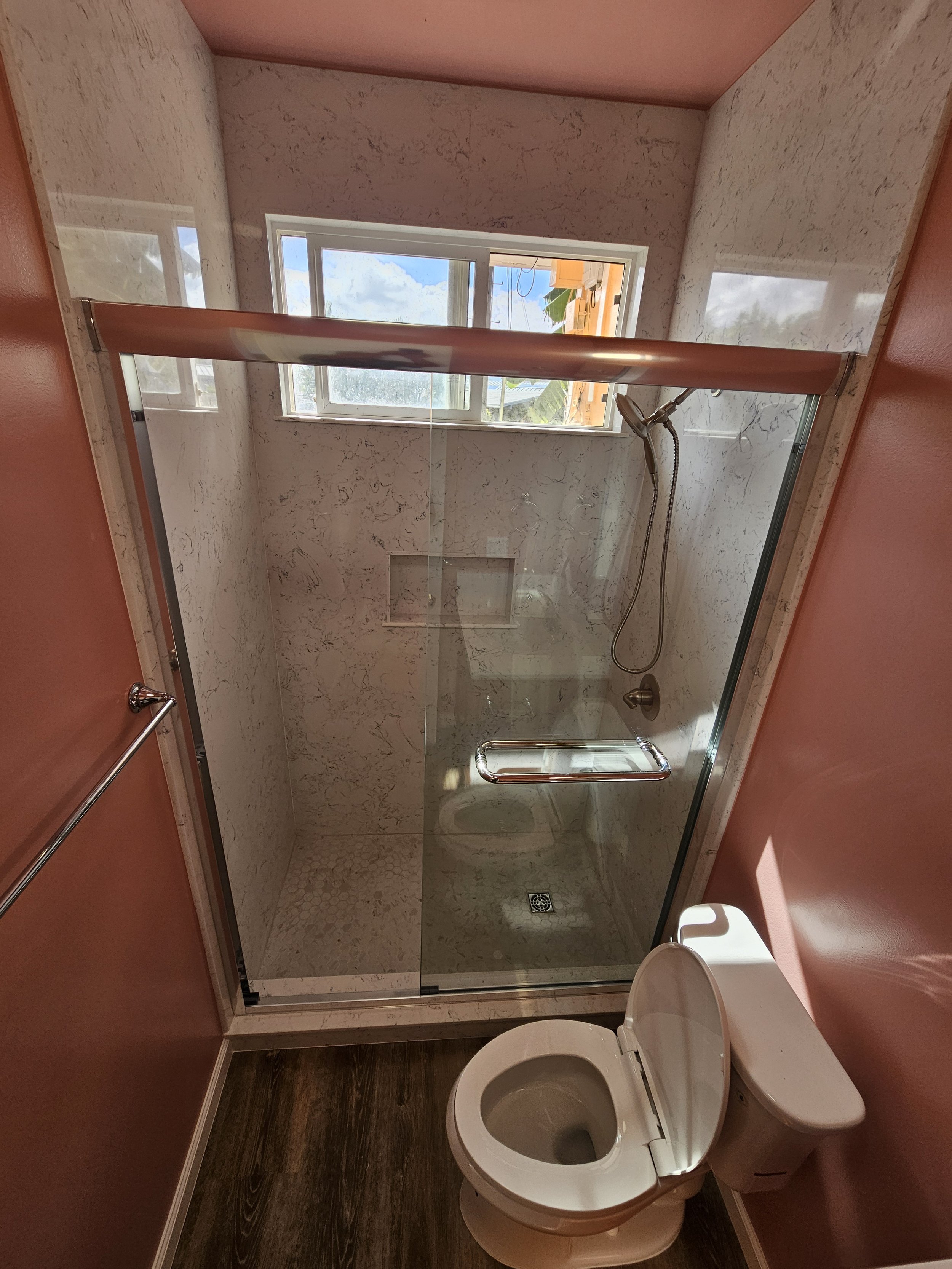 A bathroom with a glass-enclosed shower