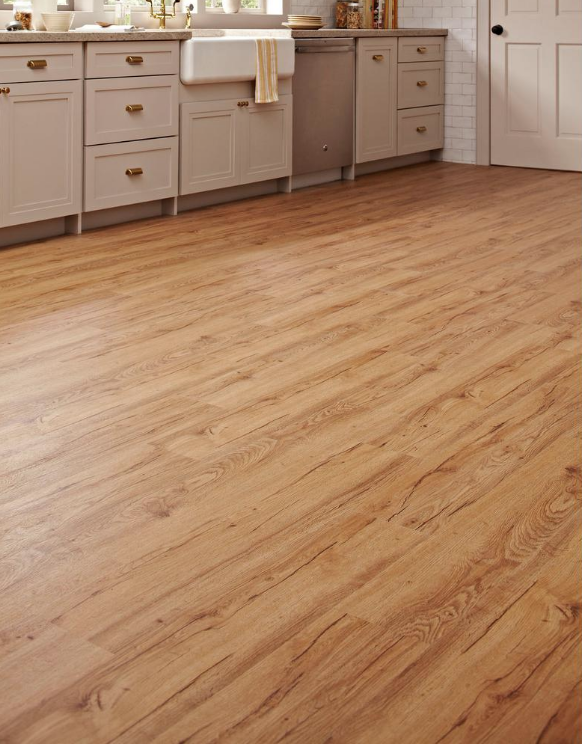Kitchen with light gray cabinets, a white farmhouse sink, and a wooden floor.