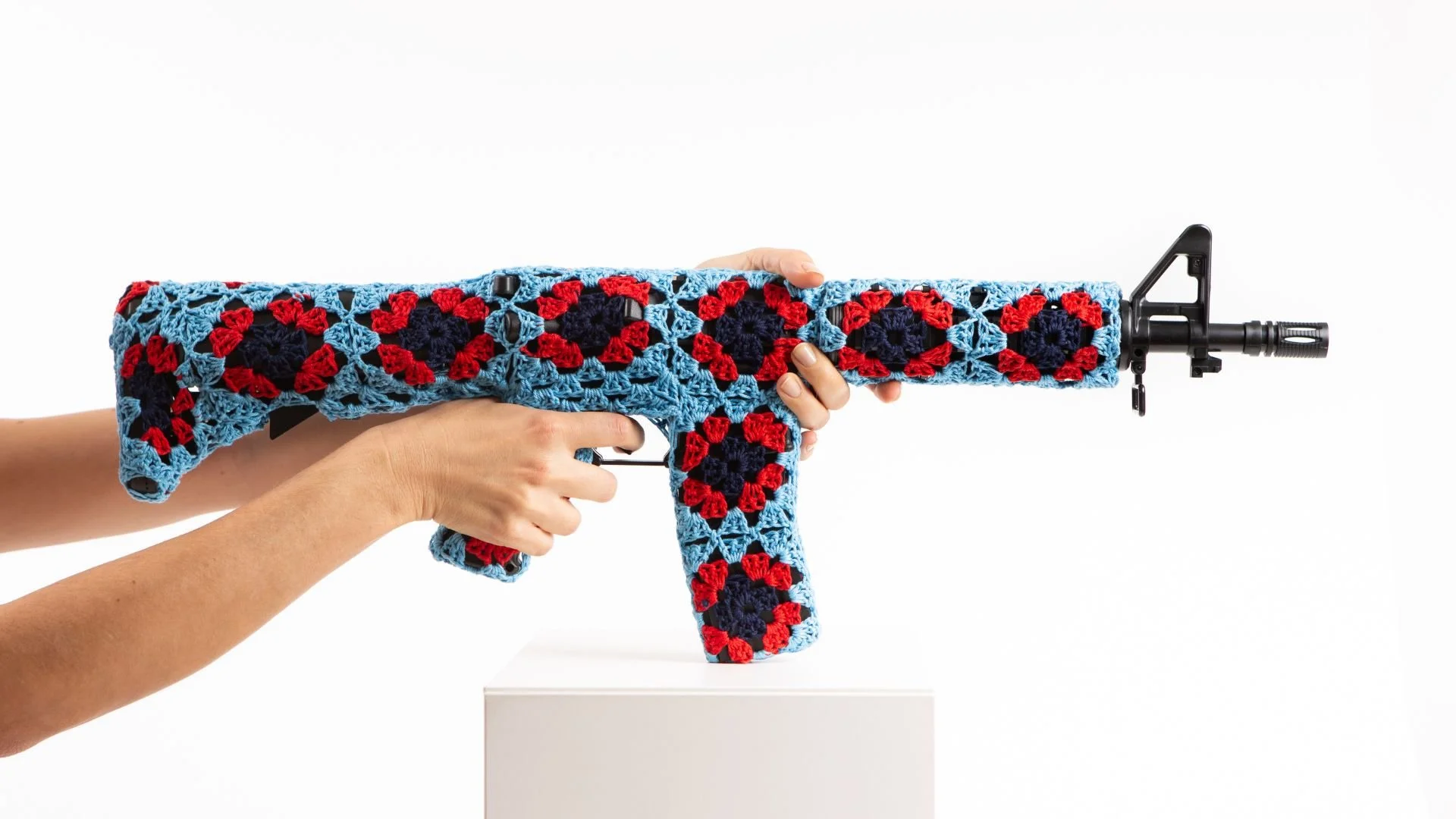 Kalashnikov rifle wrapped in hand-crocheted textile sculpture by Paris artist Sophie Inard