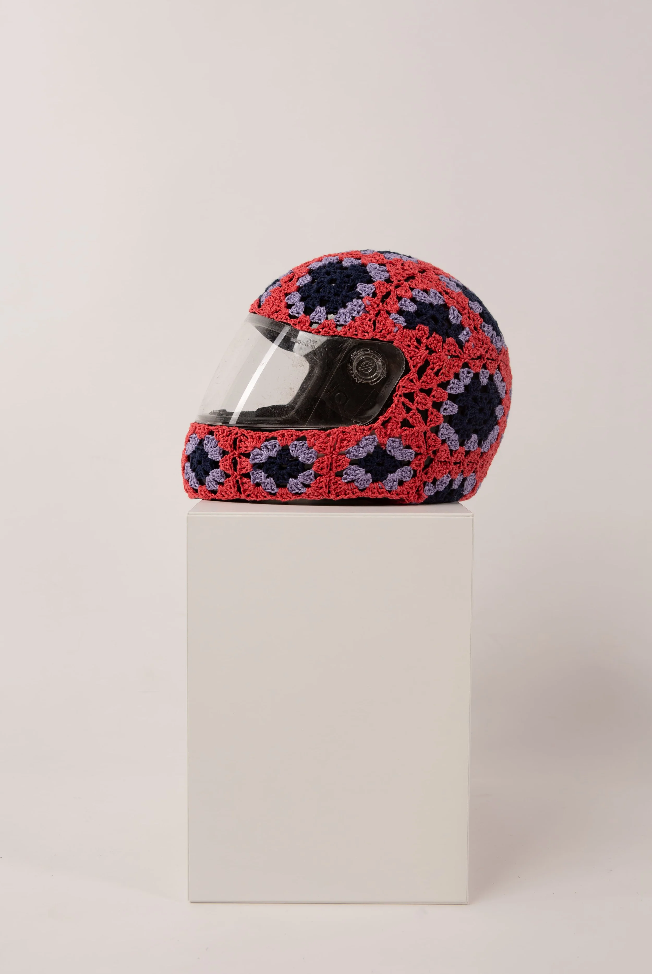 Red helmet hand-crocheted textile sculpture by Paris artist Sophie Inard