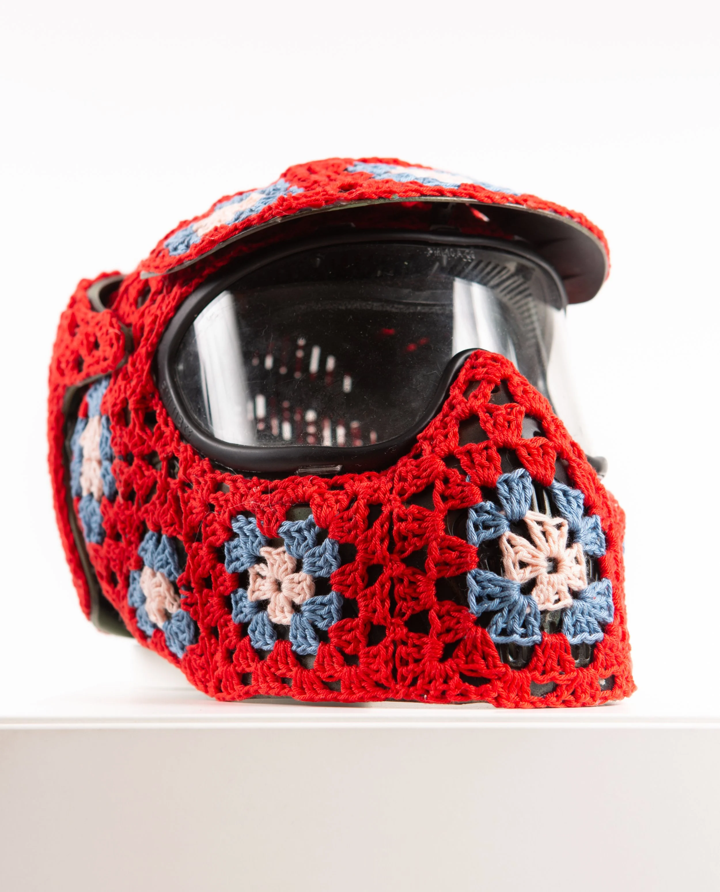 Red helmet hand-crocheted textile sculpture close-up by Paris artist Sophie Inard