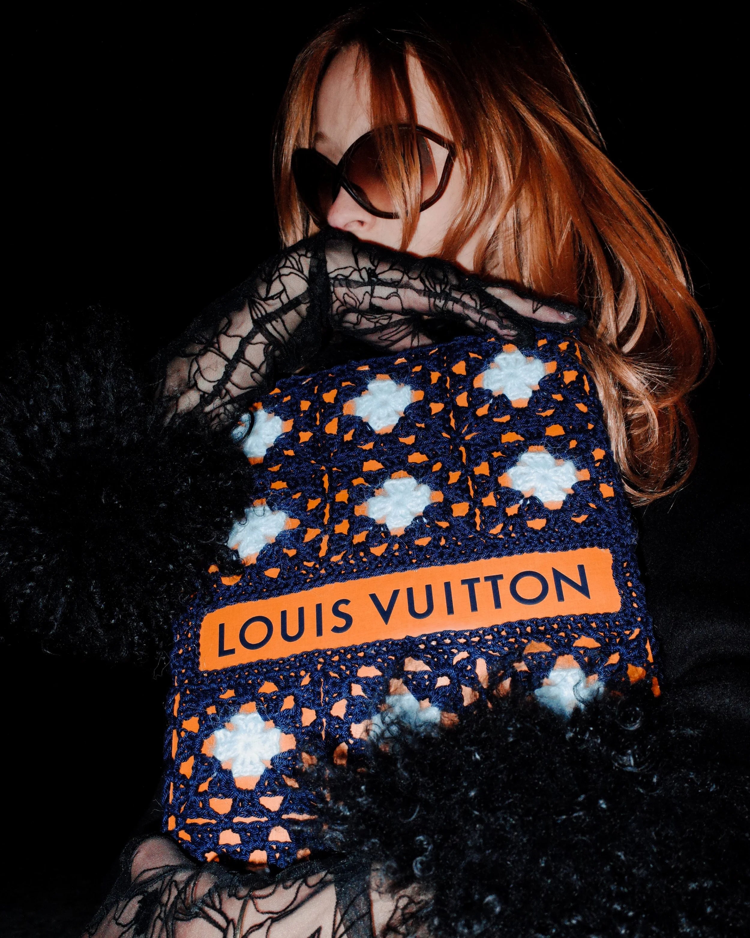 Model holding Louis Vuitton bag wrapped in hand-crocheted textile sculpture editorial by Paris artist Sophie Inard