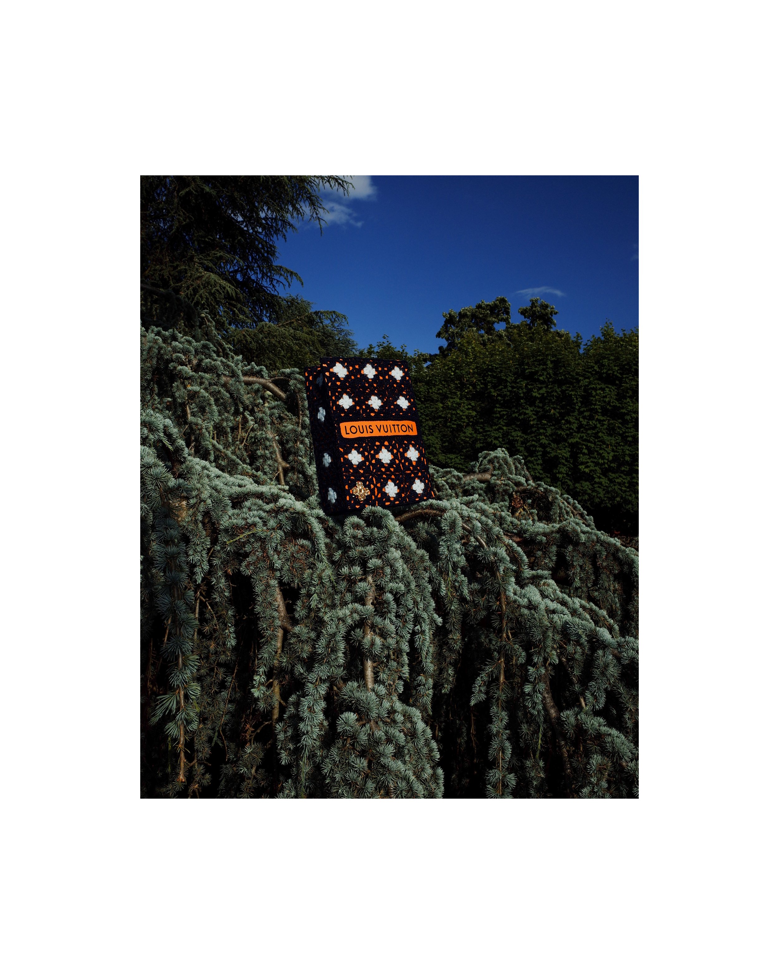 Louis Vuitton bag wrapped in navy blue hand-crocheted textile sculpture by Paris artist Sophie Inard