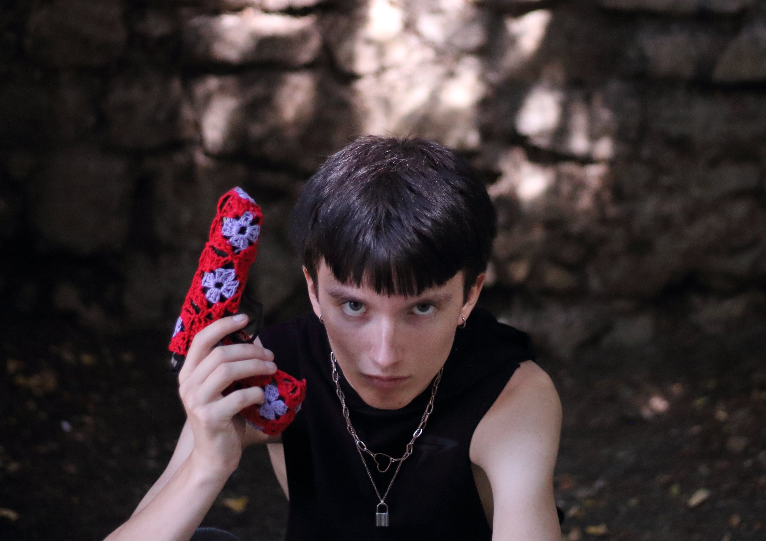 textile sculture with a gun covered with crochet as a peace symbol by Sophie Inard