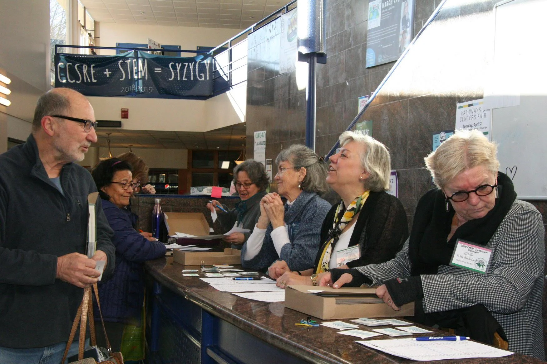 Registration chair Paul Russo behind the desk (far left) & Susan Turner (2nd from right) along with volunteers.