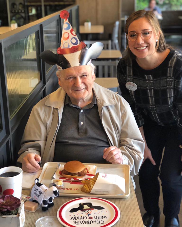 Male Chick-fil-A guest with birthday hat and breakfast