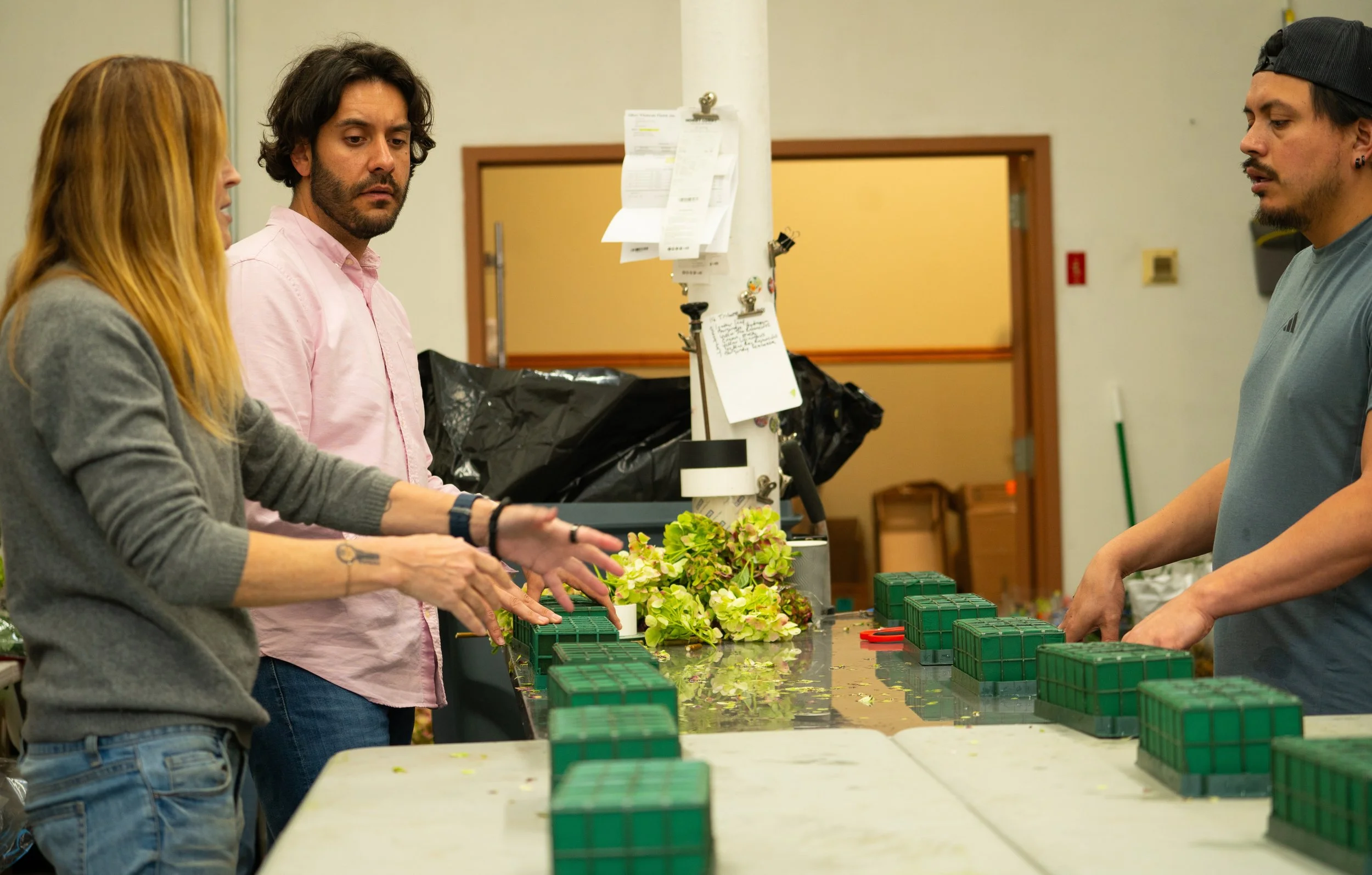 Event designer Jes in the flower studio with employees