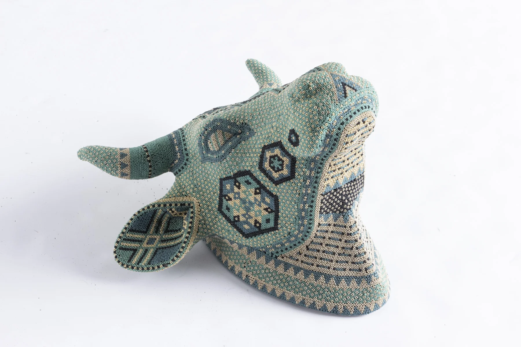  I purchased this ceramic cow skull from Target then beaded the entire surface with a 5 color design. 