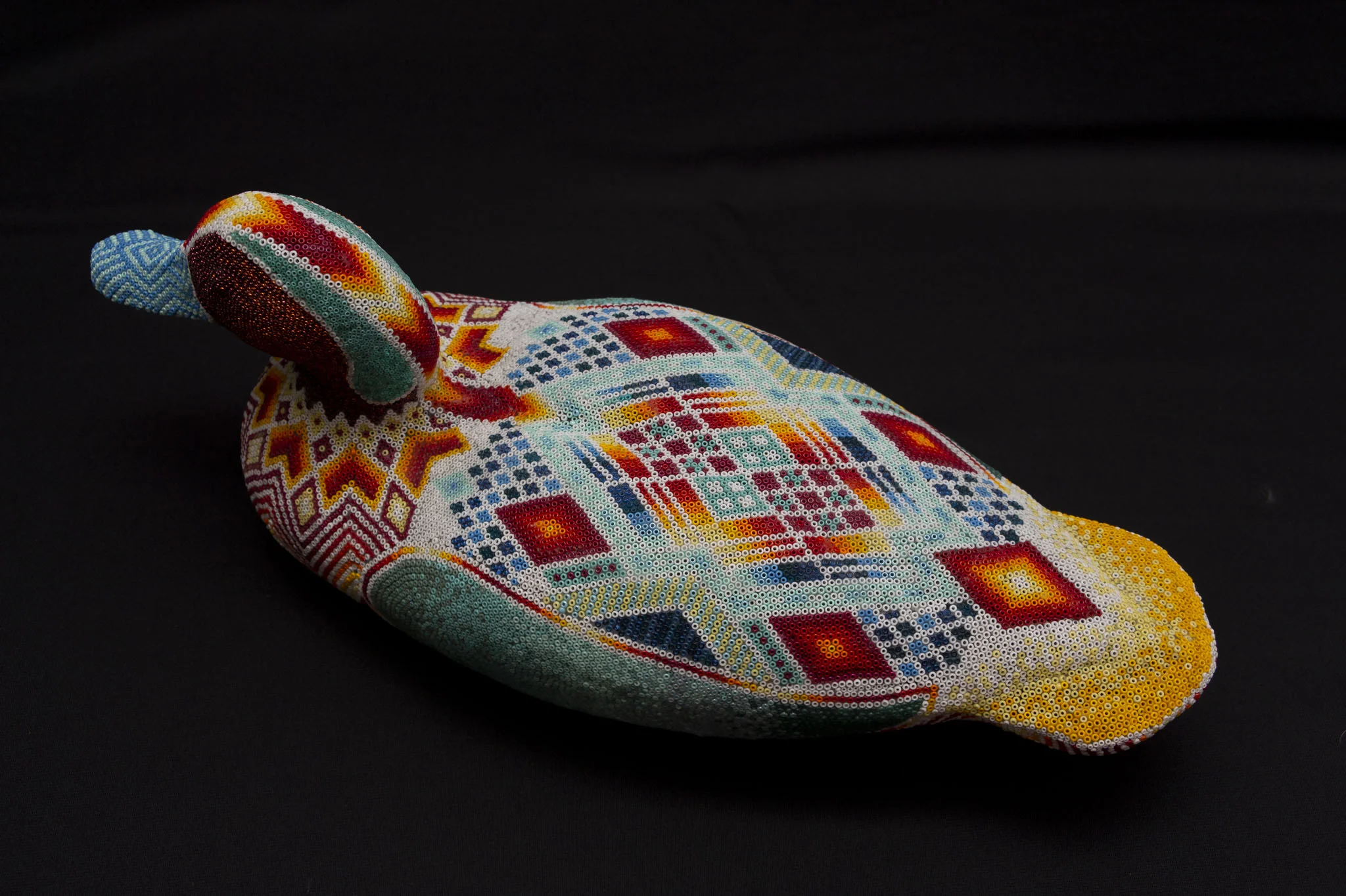  This is a floating decoy duck made out of hard styrofoam. The composition was a free-flow process- I started with the diamond shape on the top and worked out from there. 