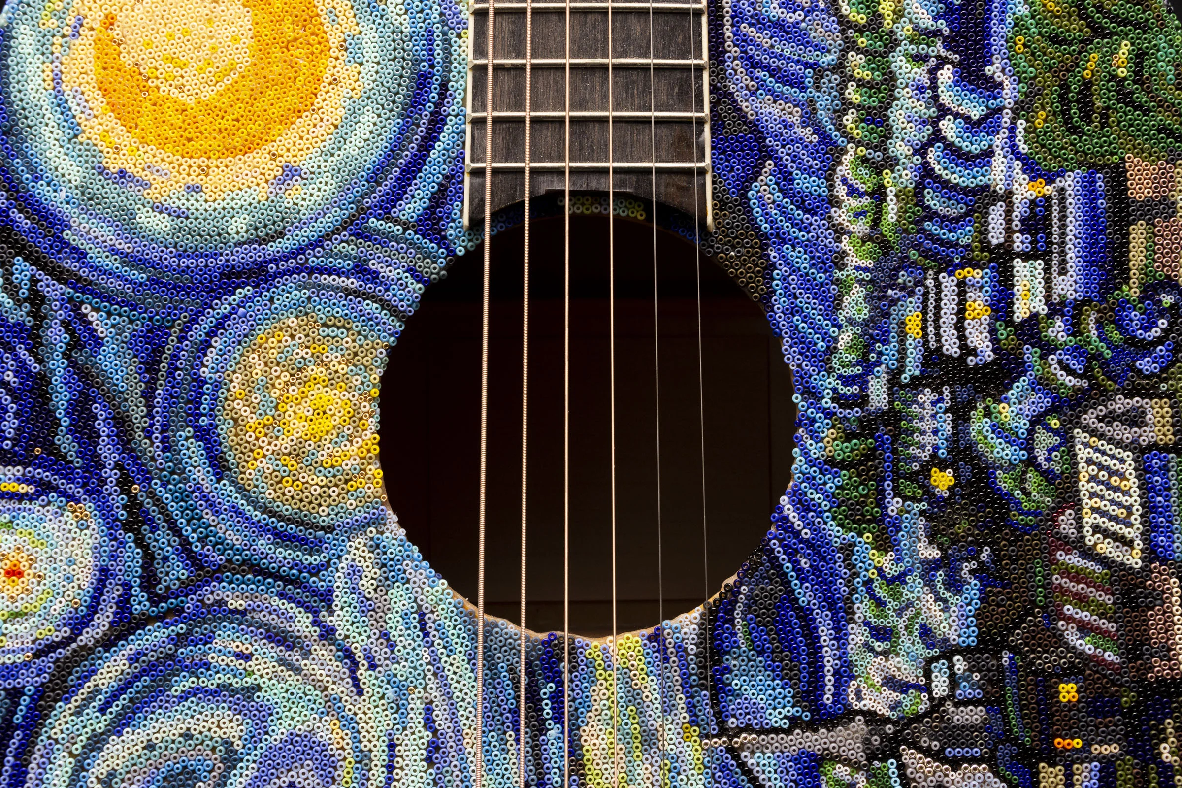  This design was done using a reference image on my computer, but I did not sketch the design on the guitar prior to beading it- I eyeballed the whole thing. 