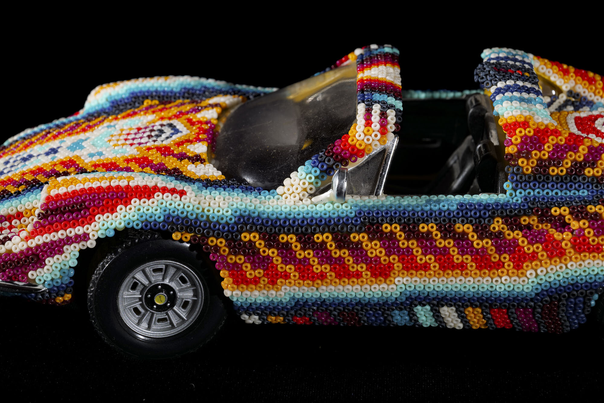  A couple months ago I found a box of die cast models from mine and my brother's childhood and I decided to use them as canvases for my bead art. This is a Ferrari Dino. Its pretty small, only 10” long, the beading process took a little over 3 days. 