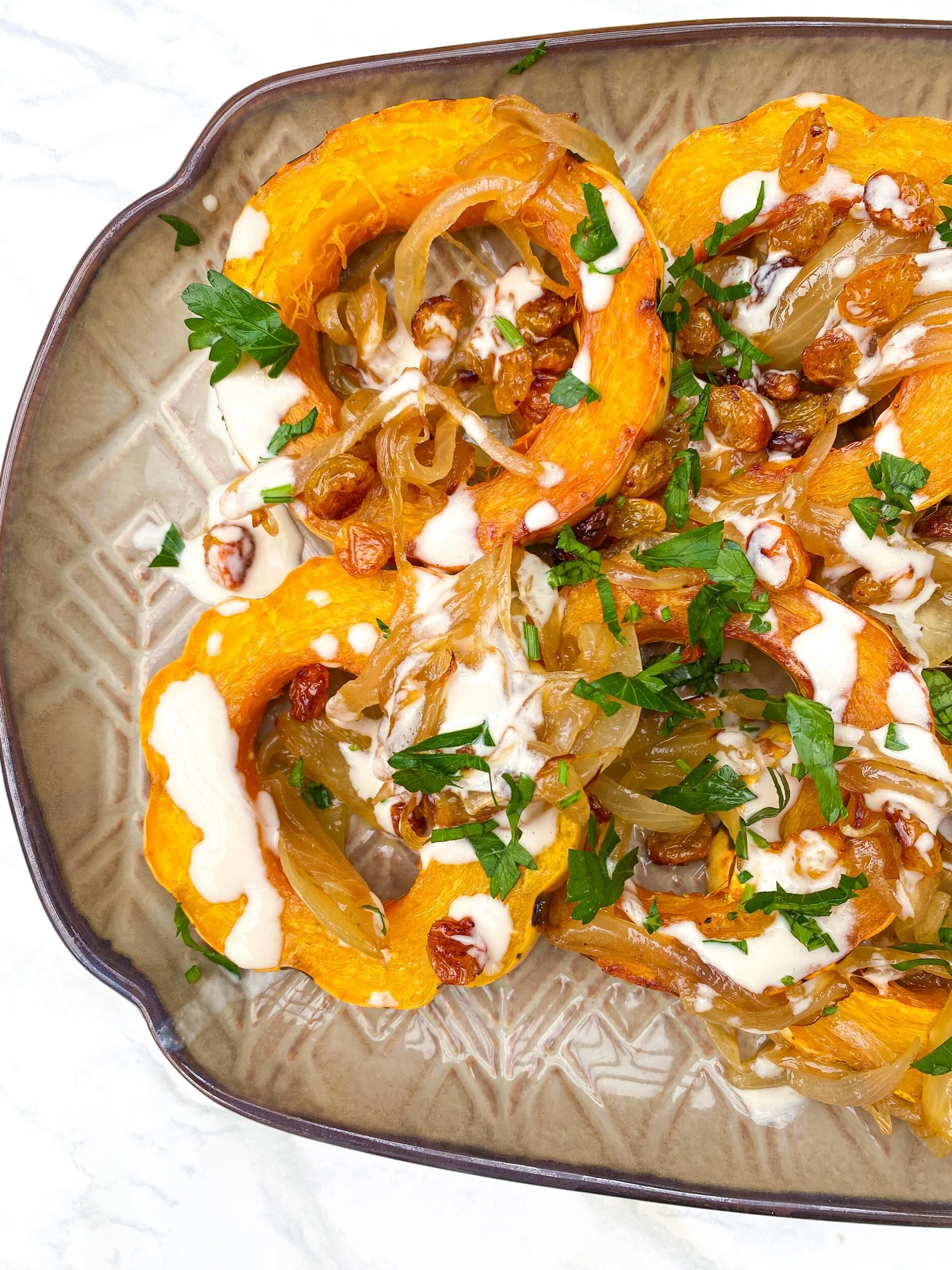 Tahini Dressed Delicata Squash with Caramelized Onion and Fried Golden Raisins