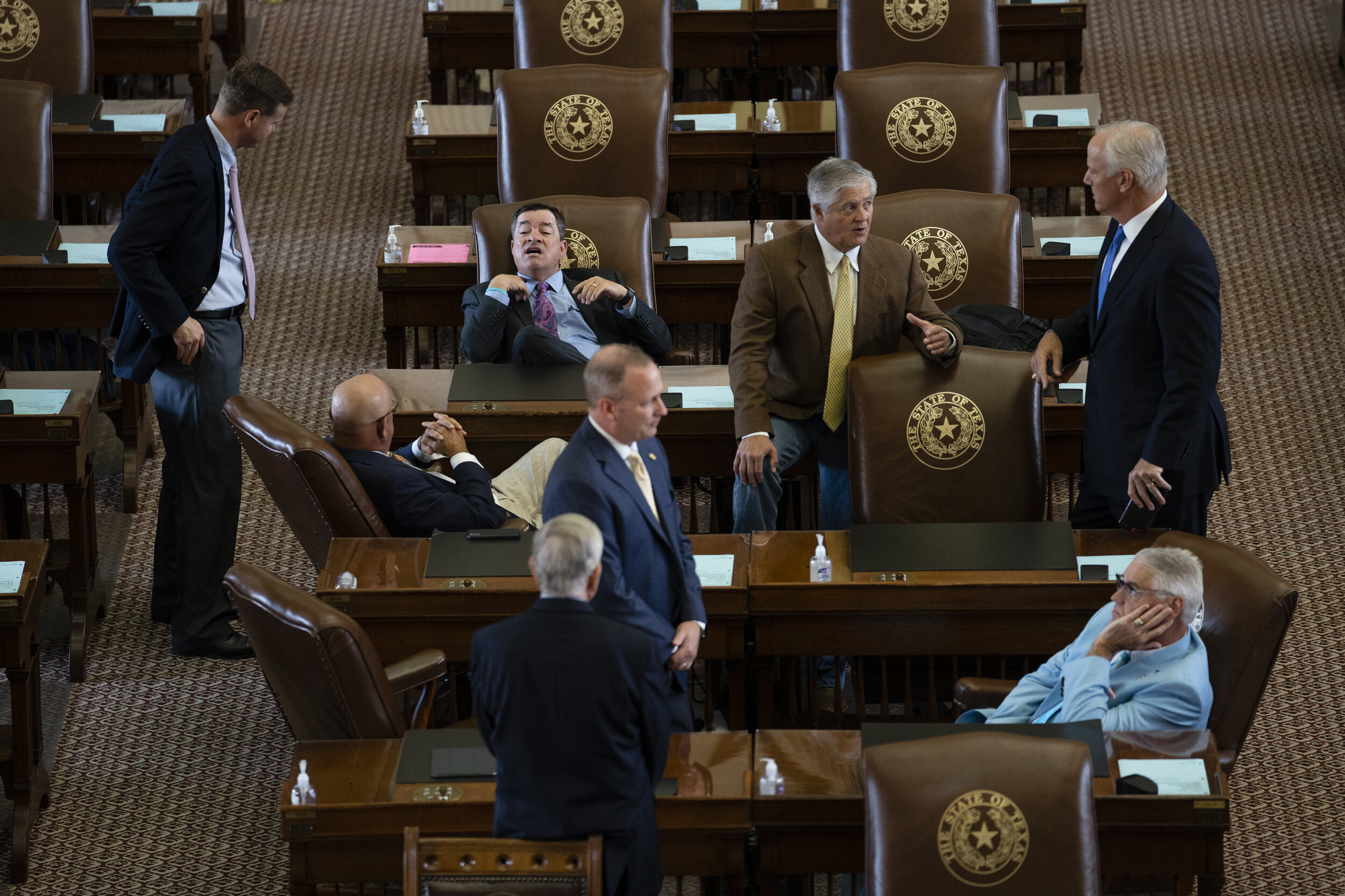  Texas legislators talk on the House floor on July 14, 2021. 