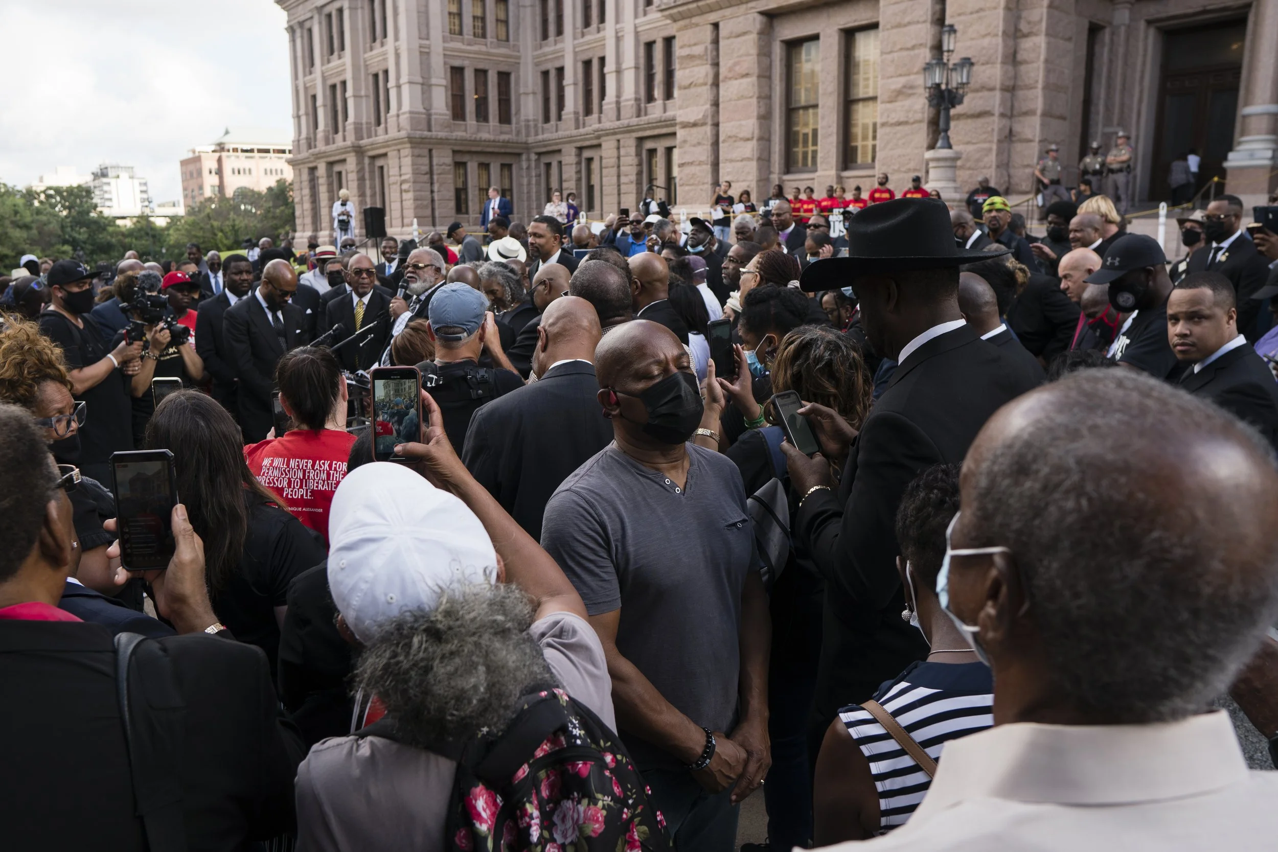  People stand on the south steps of the Texas Capitol for a Prayer and Justice march held by Texas clergy and advocacy groups on July 15, 2021.  