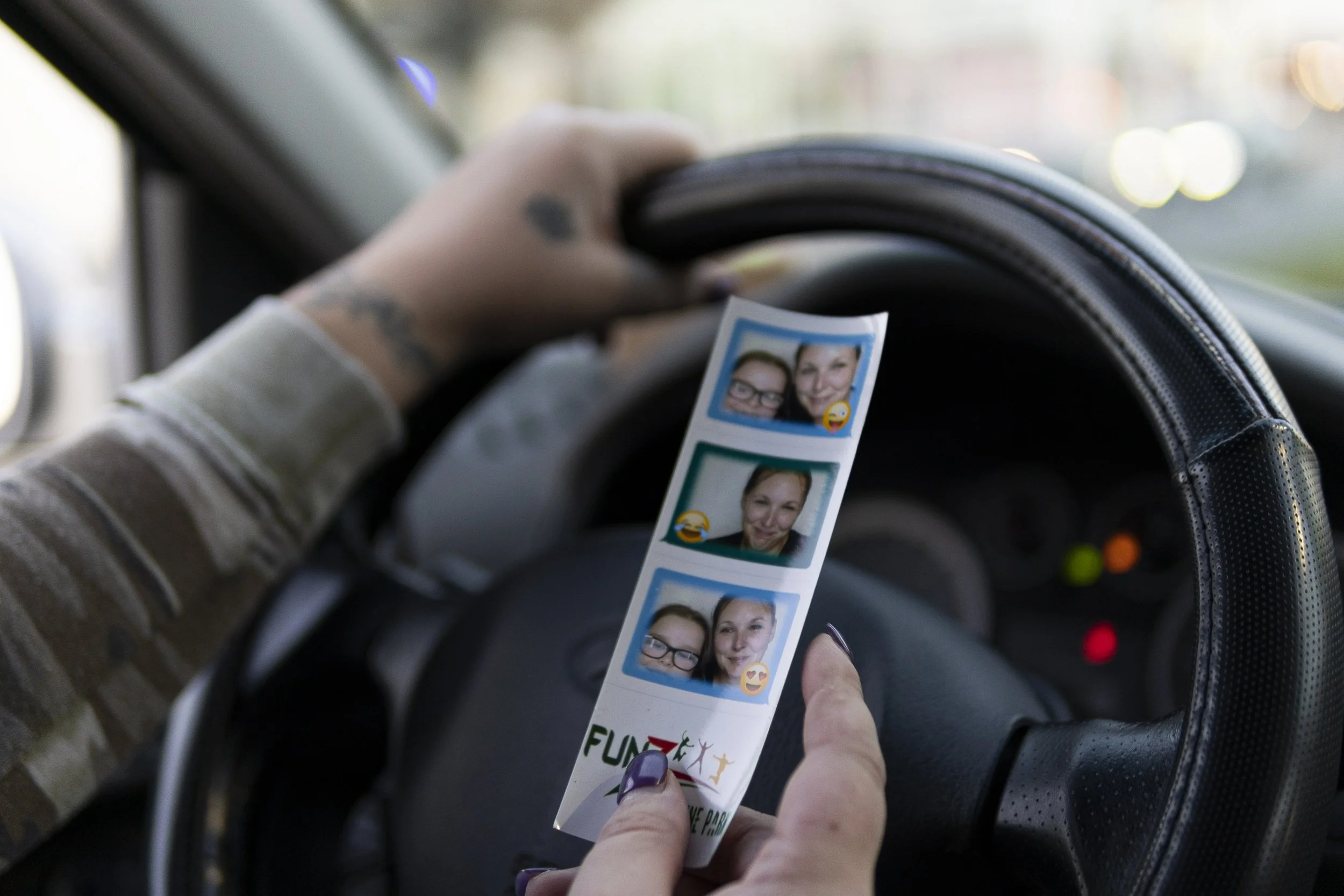 Shellie holds photo strip of her and Bella from the day they were reunited after months of being apart. Shellie says that the photos symbolize the beginning of the fight for her daughter. She keeps them on her dash as a reminder of what is important.