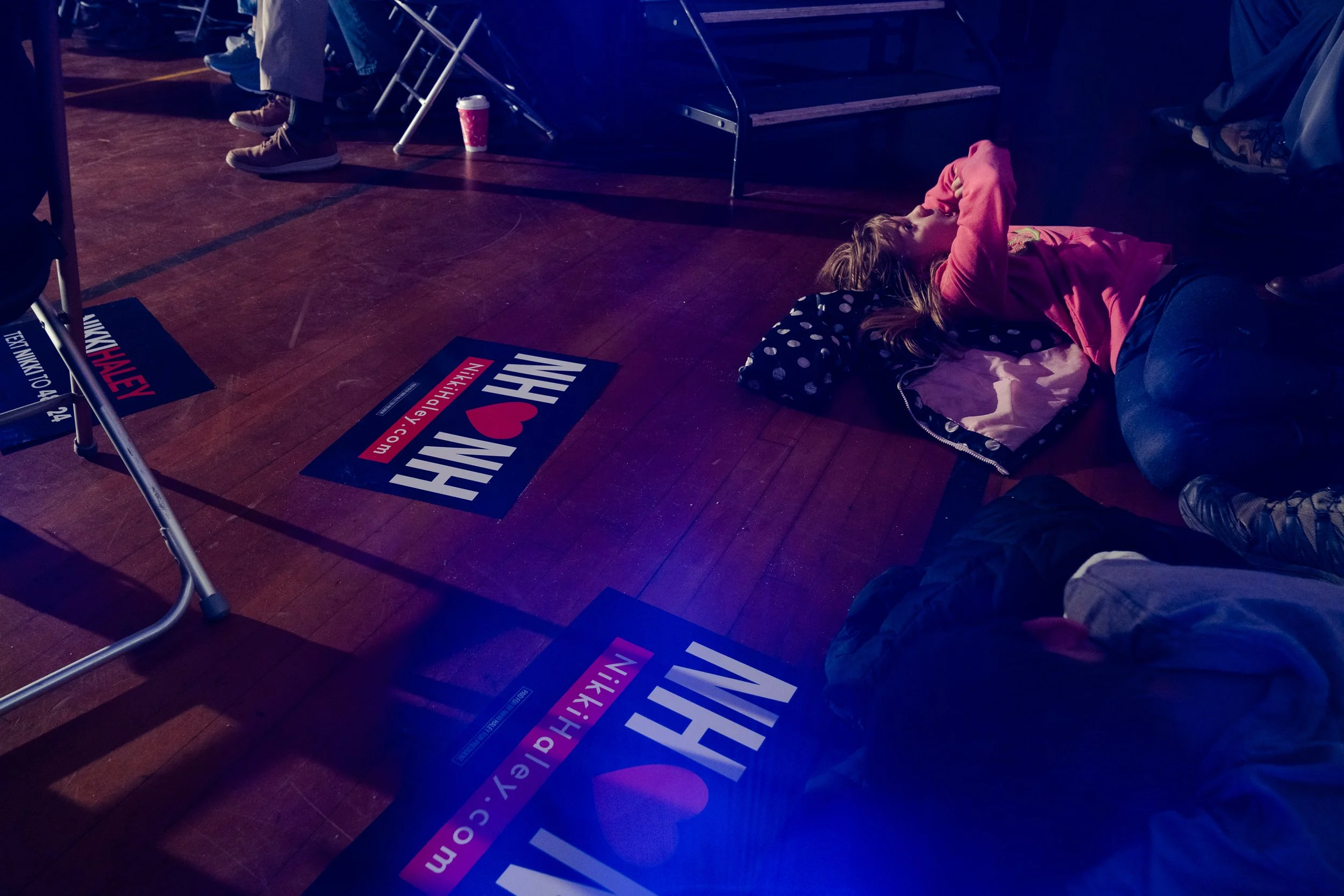  Izzy Lee, 8, rests on the floor while GOP candidate and former U.N. Ambassador Nikki Haley speaks during a town hall at Newport Recreation Center in Newport, N.H. on Dec. 14, 2023. 