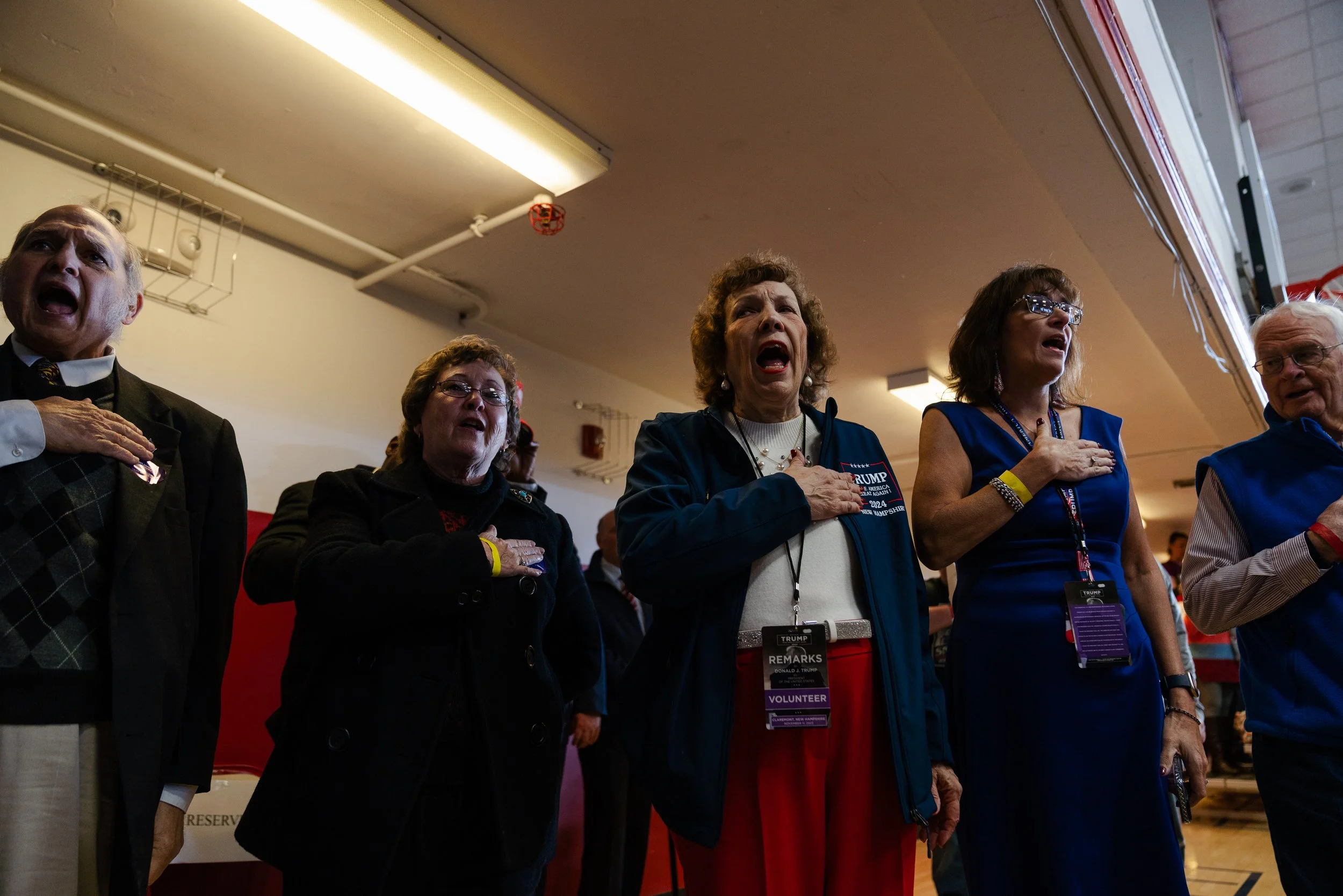  Supporters of former president and GOP candidate Donald Trump sing the national anthem during a campaign event at Stevens High School in Claremont, NH on Nov. 11, 2023. 