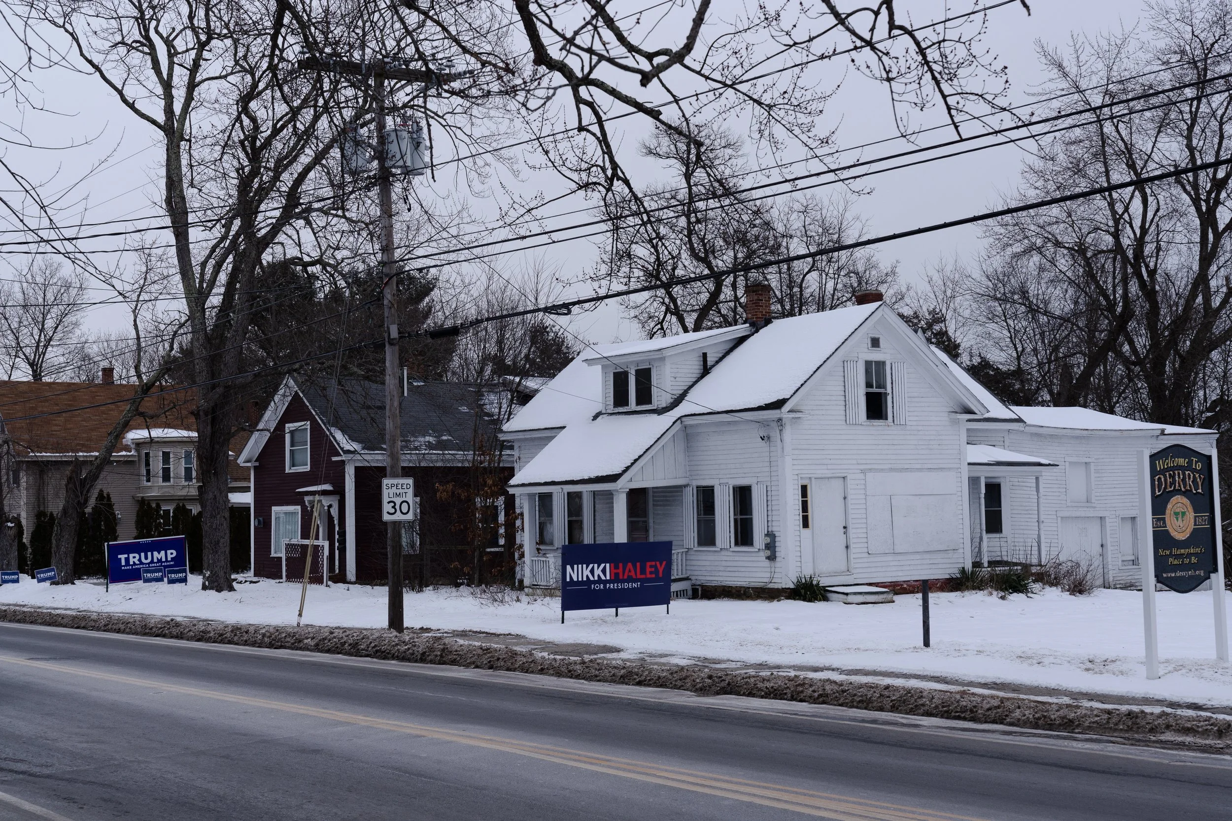  Neighboring signs in support of former President Donald Trump and former U.N. ambassador Nikki Haley are seen in Derry, NH on Jan. 19, 2024. 