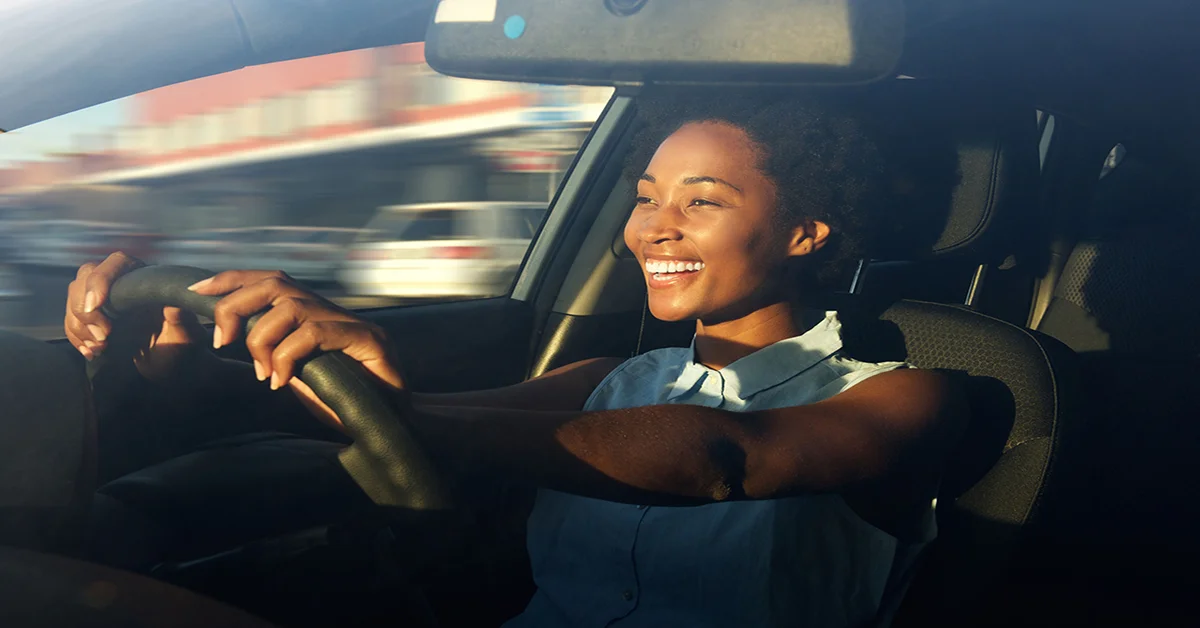 60626289 - portrait of smiling young african american woman driving a car