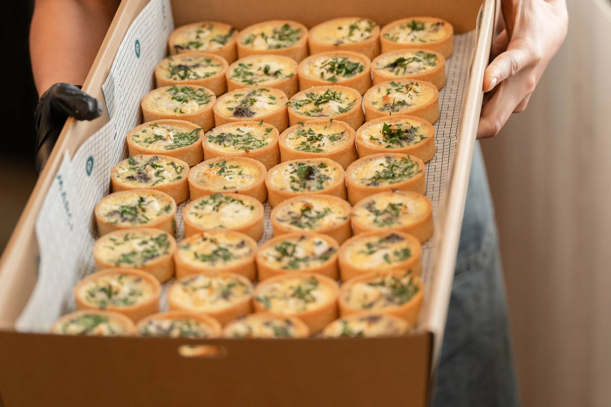 A catering box of house-made mini quiches from Marché's Glenferrie Road kitchen