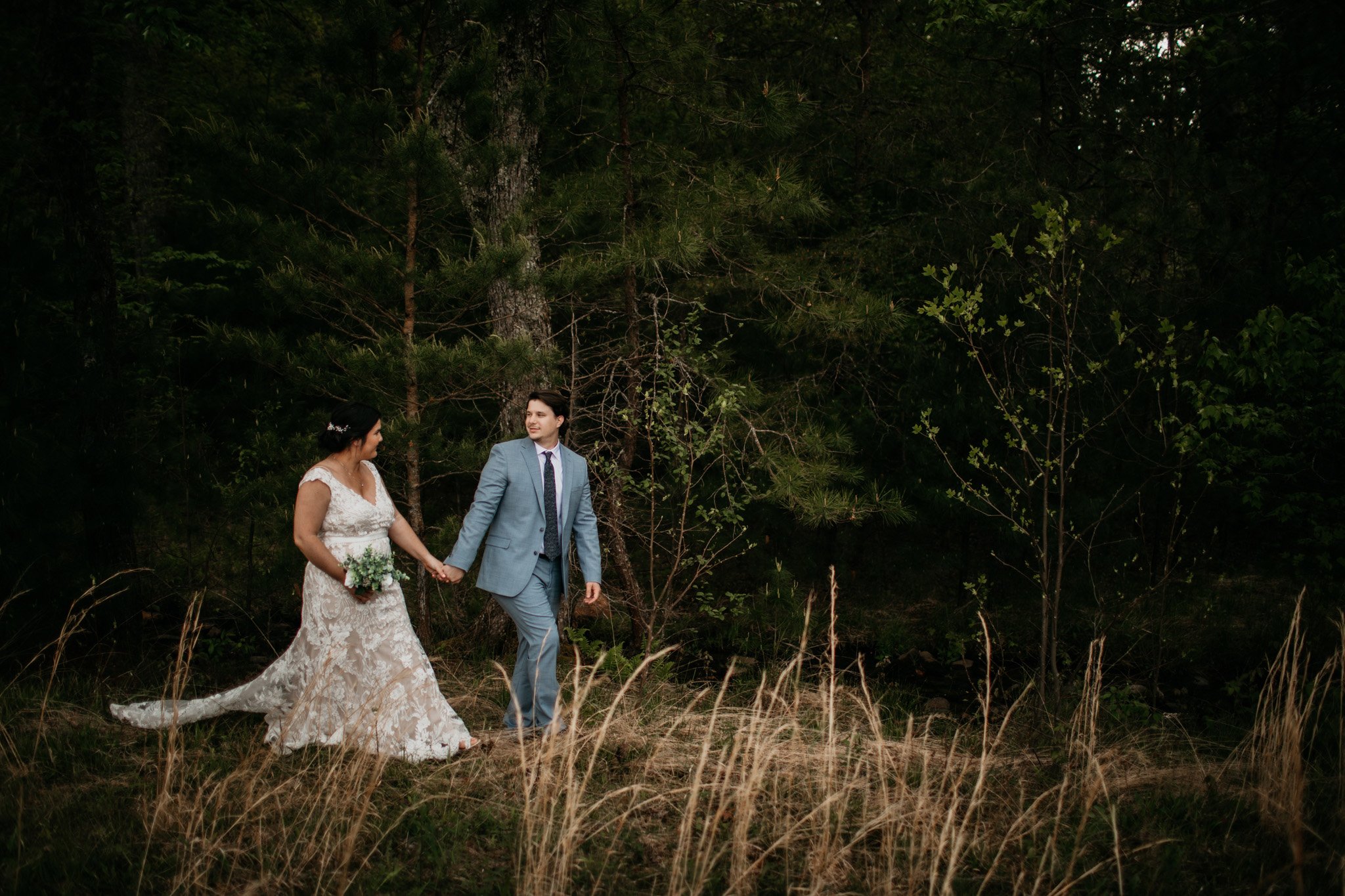cades-cove-elopement-effortless-elopements-couple-walking-in-woods.jpg