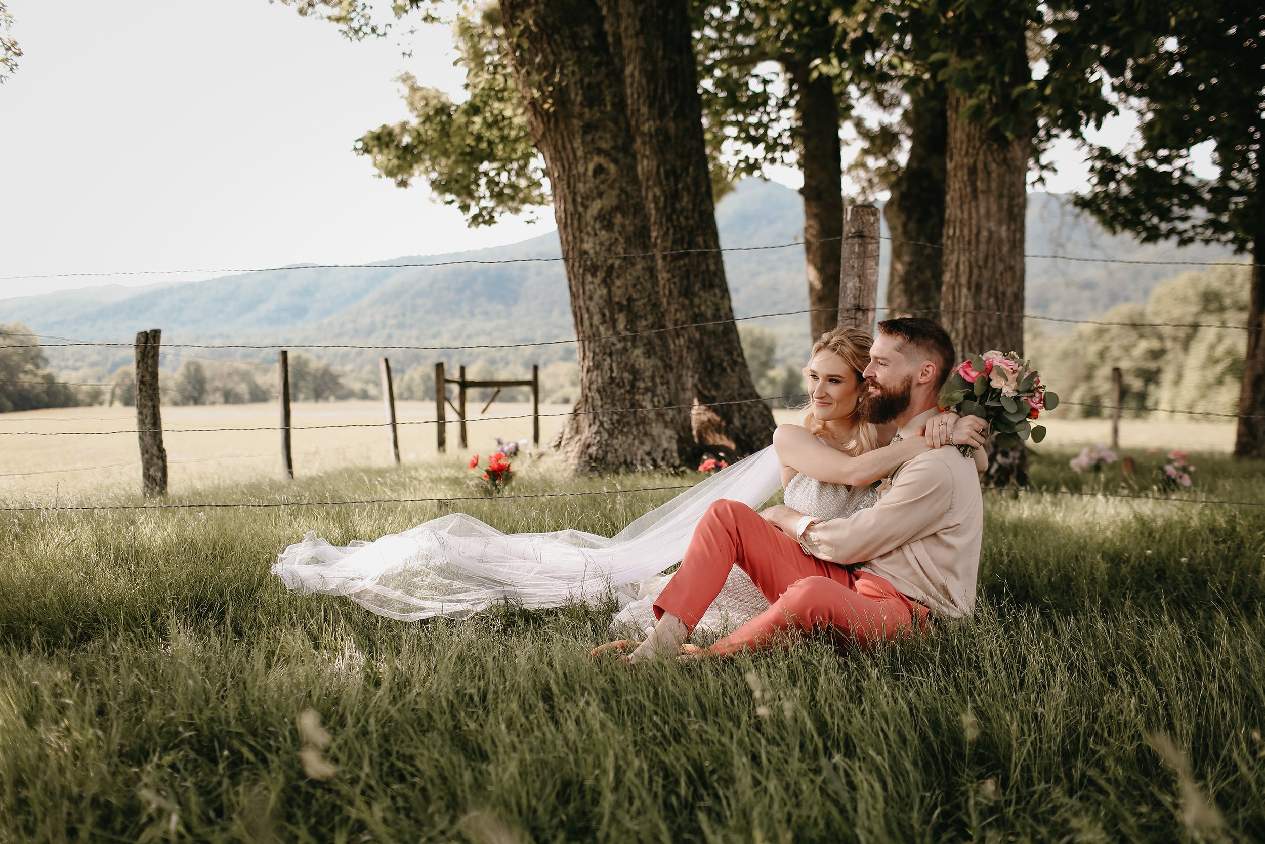 cades-cove-wedding-couple-sitting-in-grass.jpg