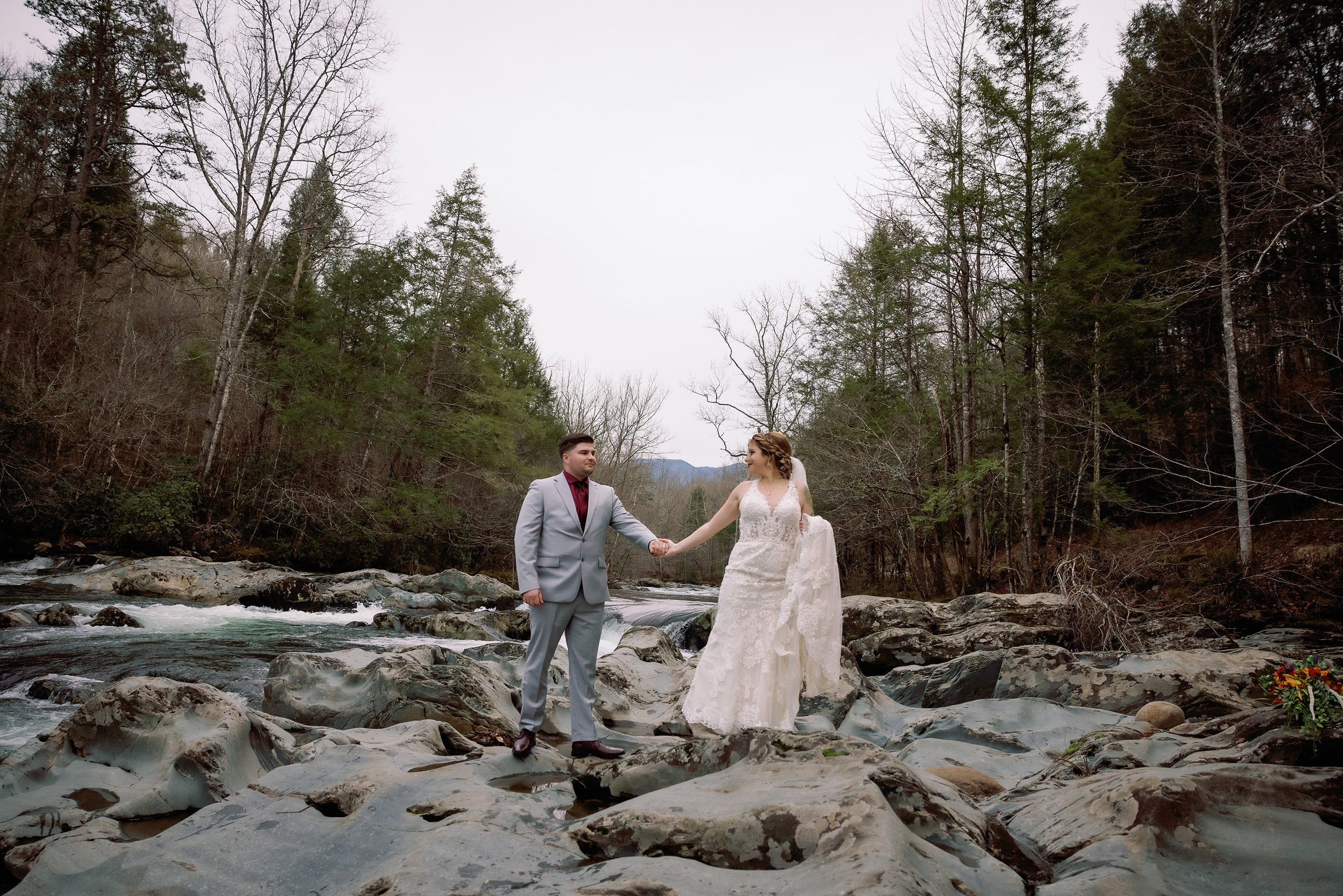 greenbrier-elopement-couple-walking-over-rocks.jpg