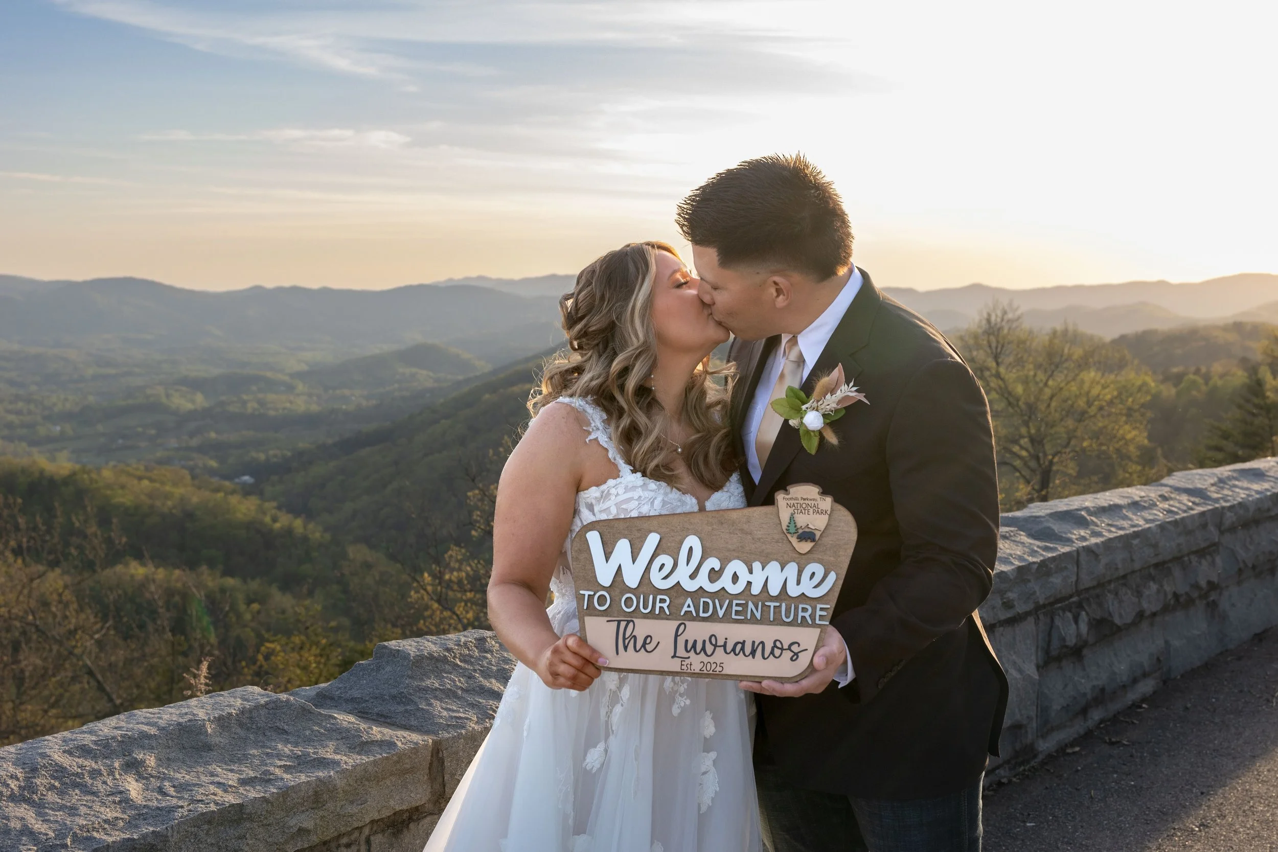 Couple with national park sign after eloping in the Great Smoky Mountain national park
