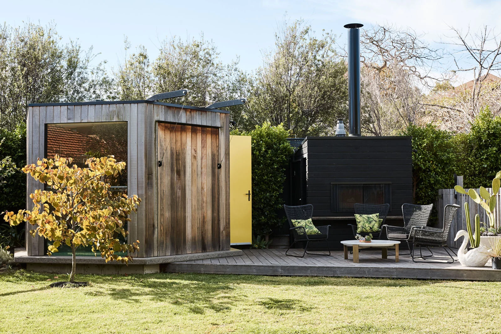 Hexagonal outdoor room timber cladding and yellow door