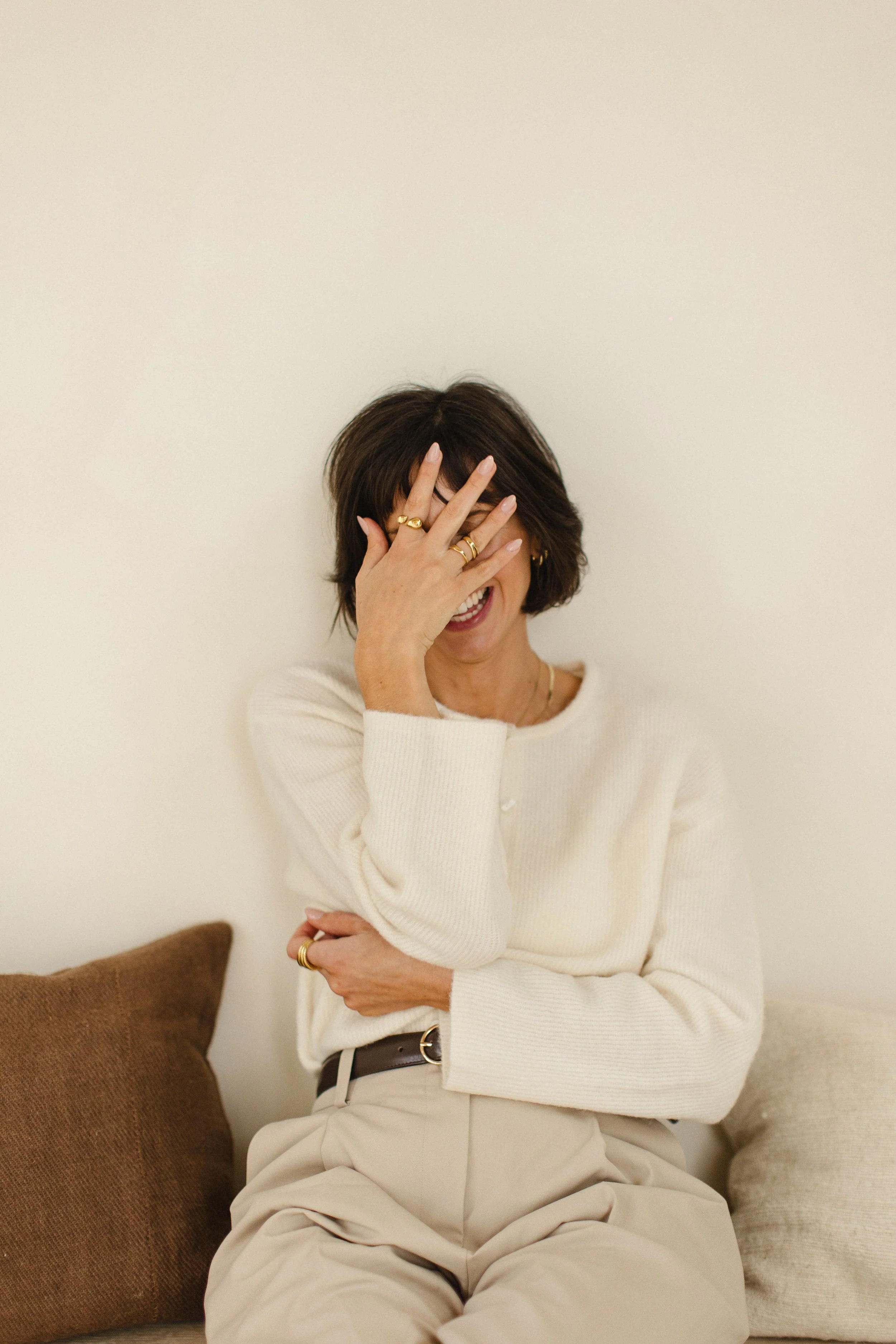 female founder hiding behind hand