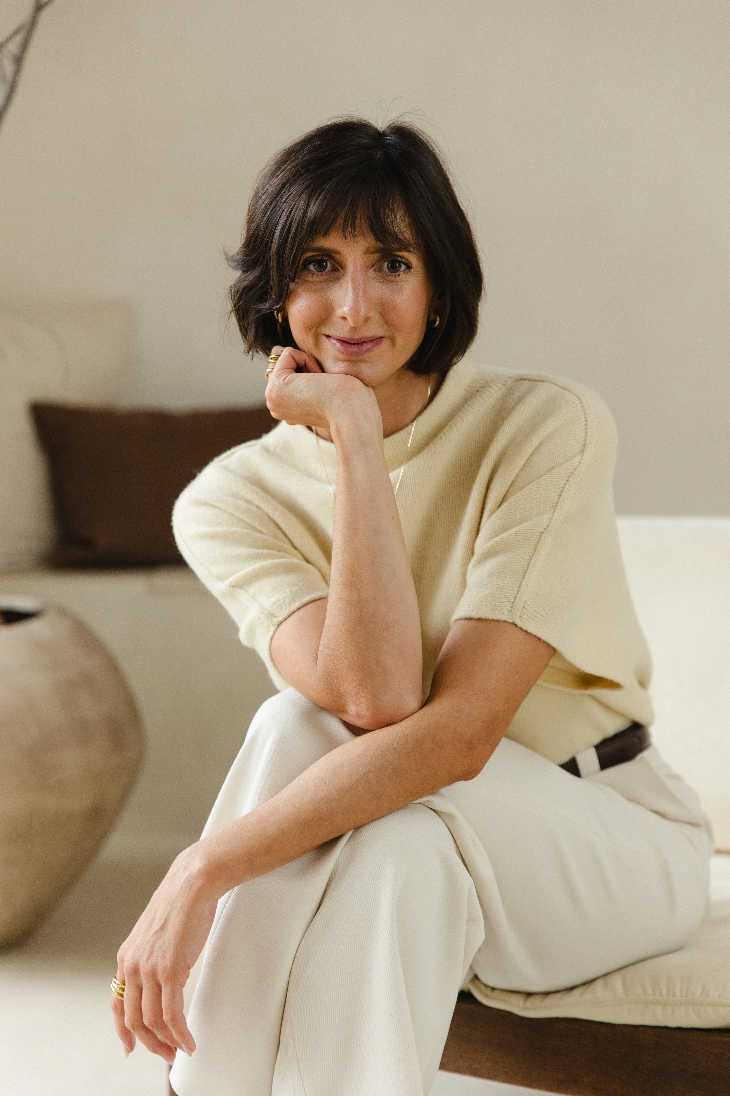 female founder confident feminine portrait in neutral setting