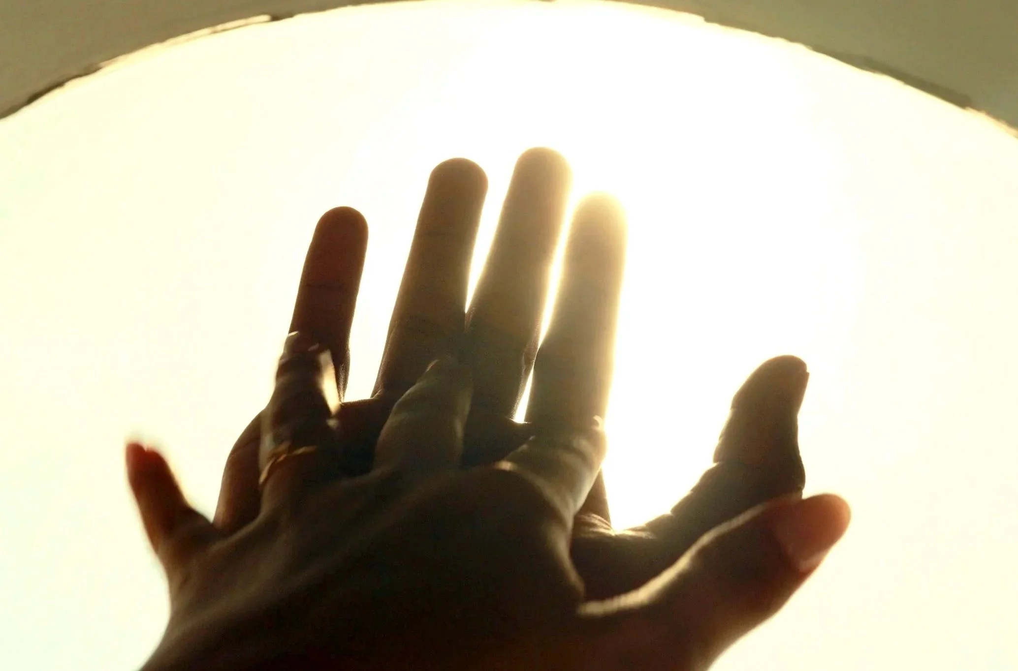 Couple’s hands touching each other in a well-lit background.kground
