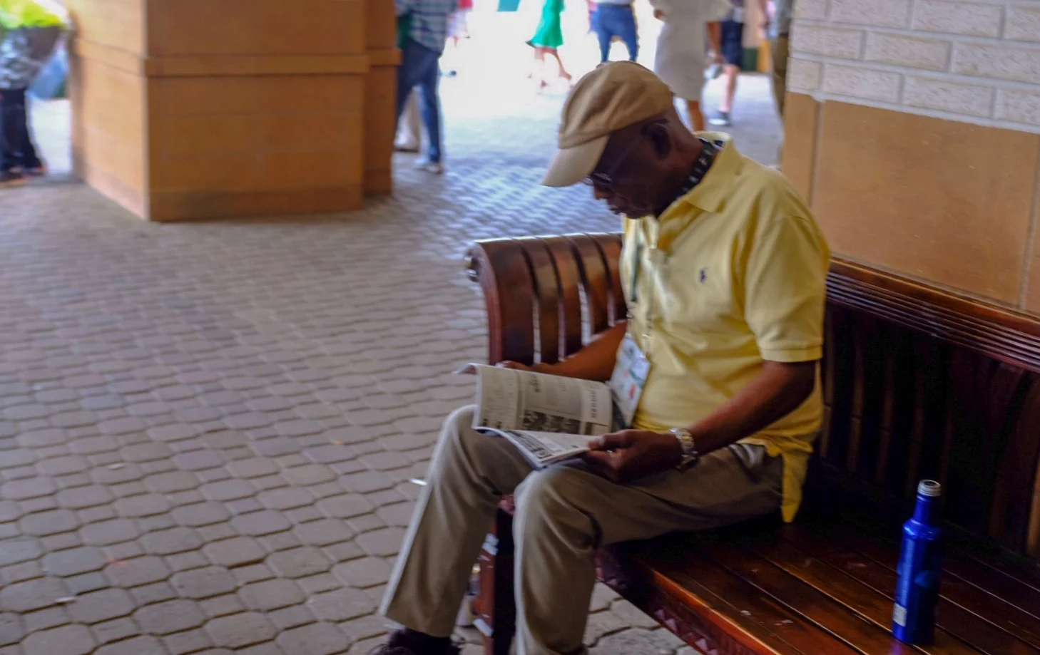 Nothing special to this other than an attempt to grab a decent street snapshot. Worker taking a break to check out the racing form at the horse track. 