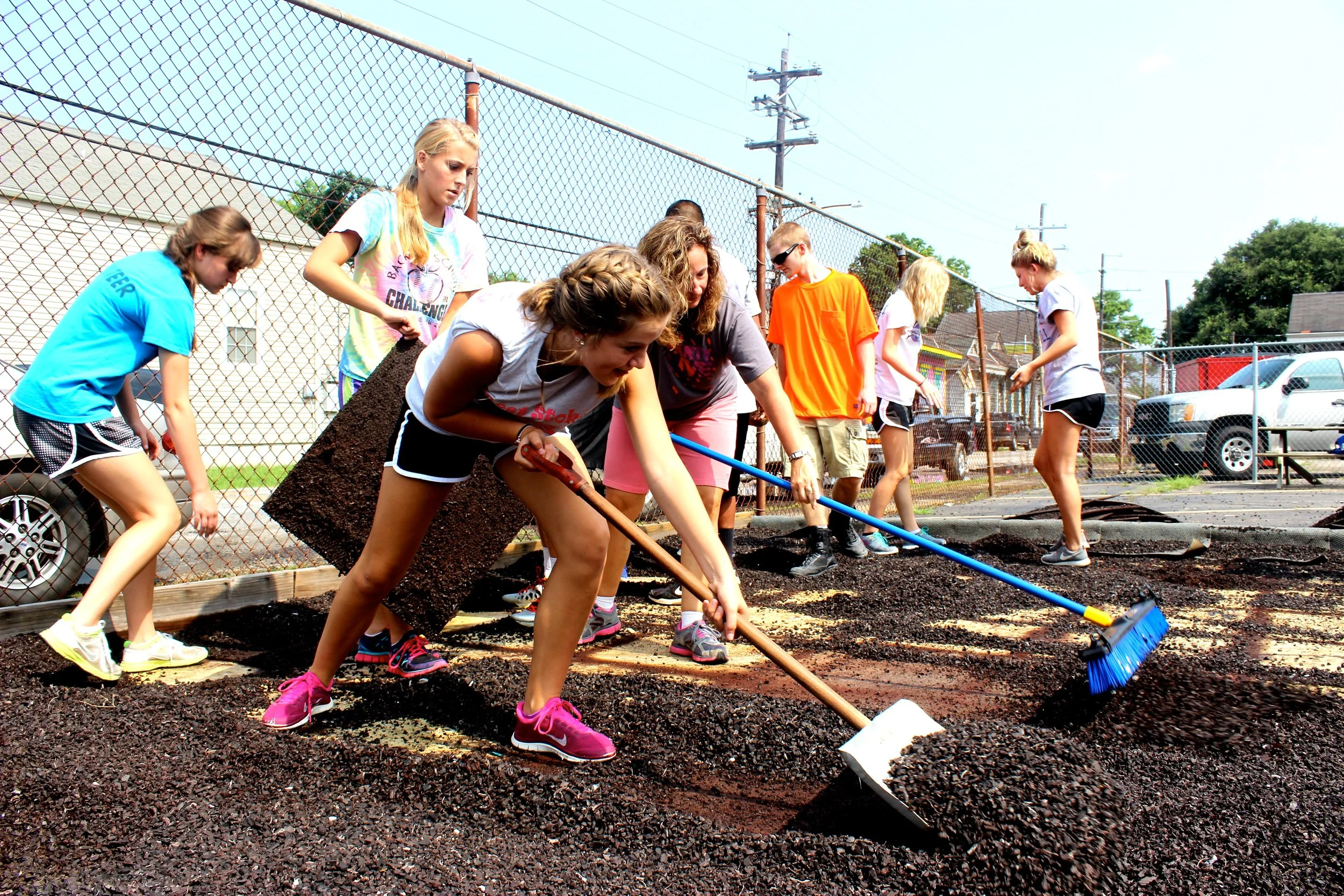 Volunteers shoveling potting soil in New Orleans