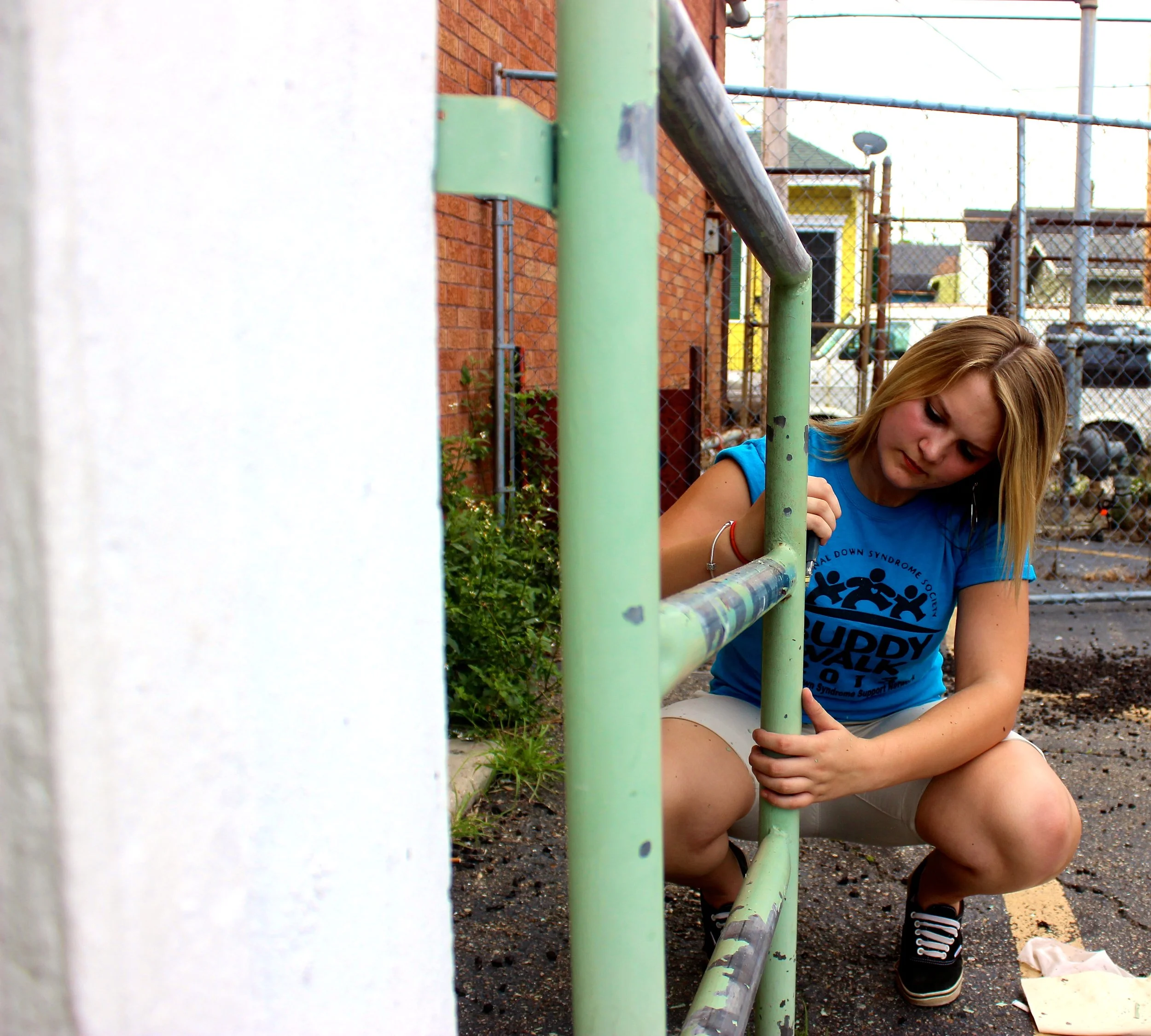 Volunteer work chipping off old paint at a New Orleans school