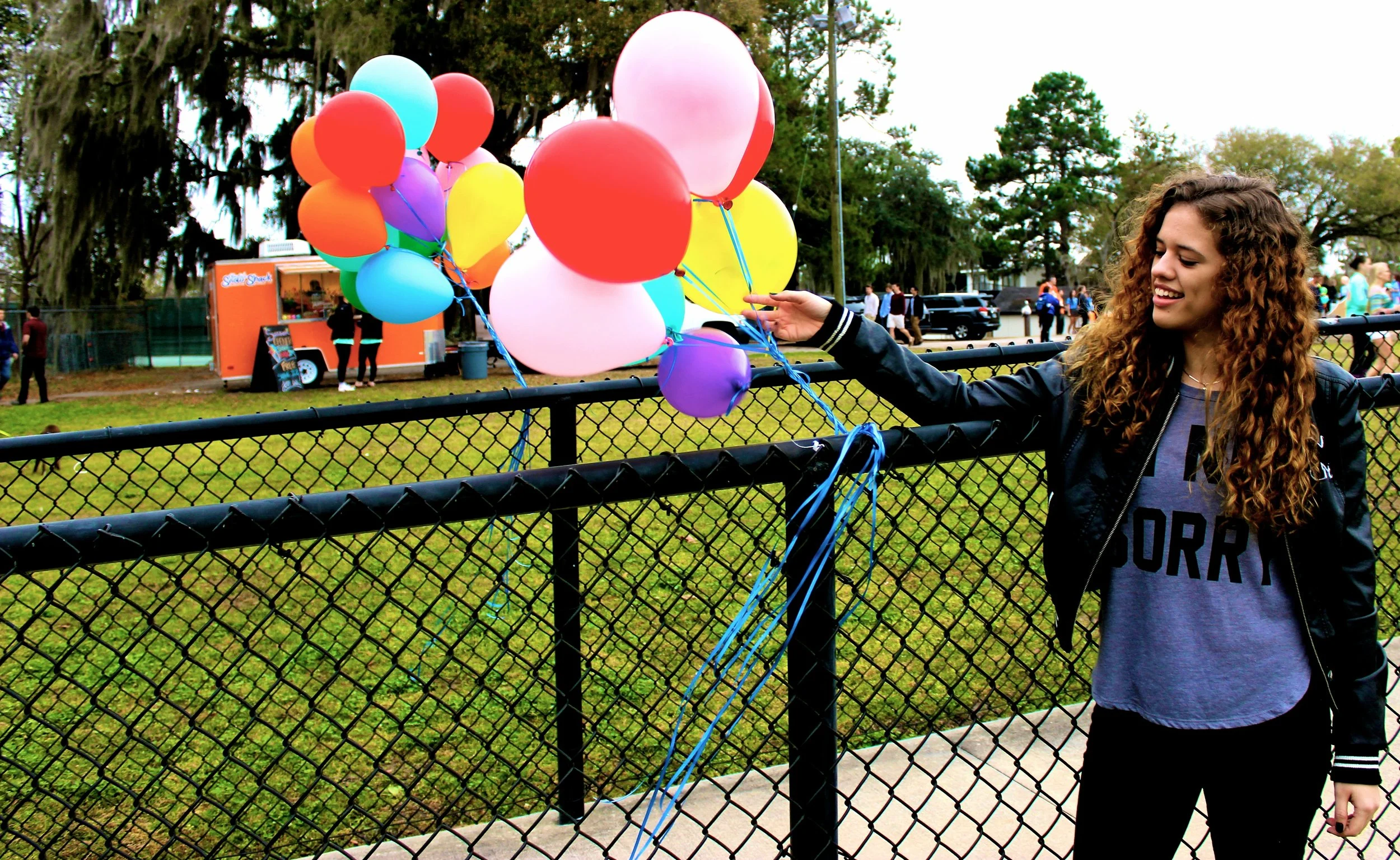 Woman holding balloons in New Orleans