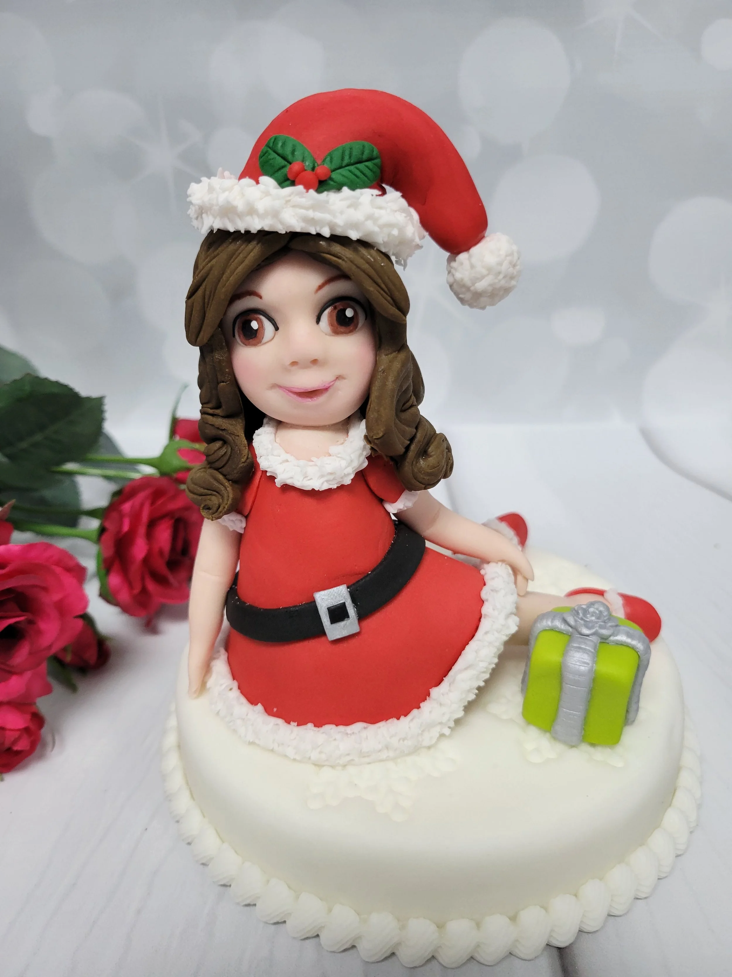 Santa girl sitting in her santa dress with a present
