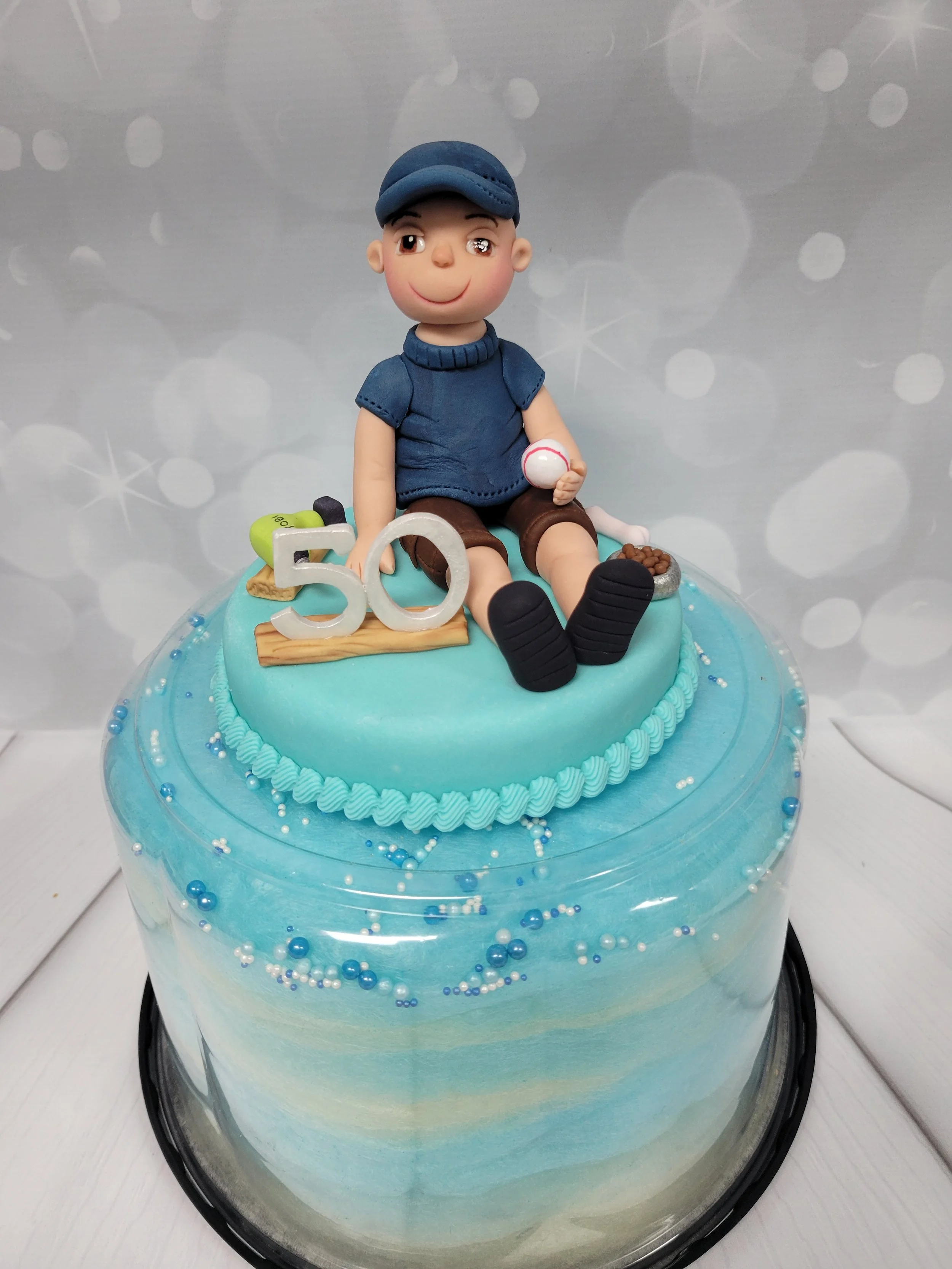 Construction worker cake topper on a cotton candy cake