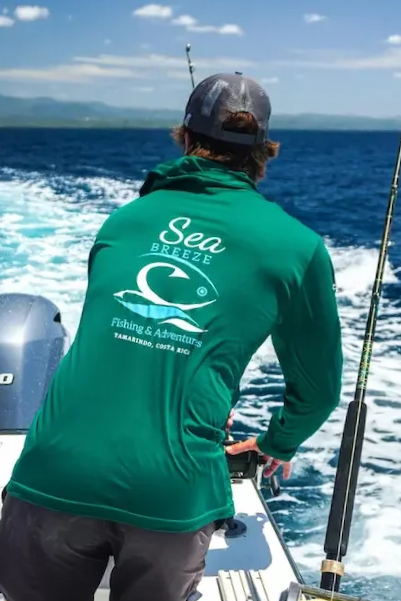 Our SPF50 long sleeve in GREEN in action on the boat in a bright sunny day of index10 keeping anglers cool and protected