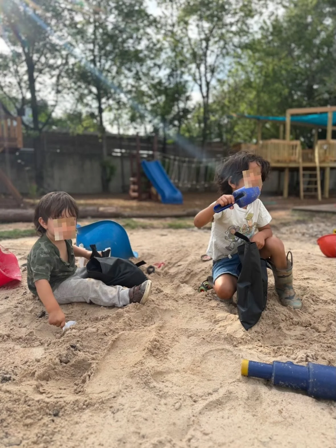 Helpful &amp; playful. Filling sandbags to hold down our shady blue canopy. #atxnaturepreschool #naturekids #outdoorplay #sandpit #freeplay
