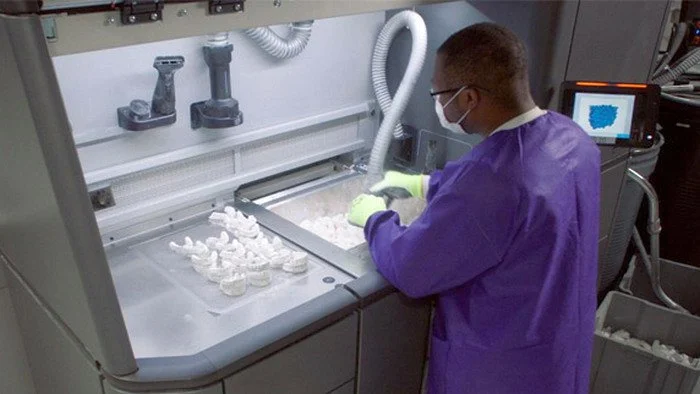 Technician making sure dental retainers are ready to create flawless smiles!