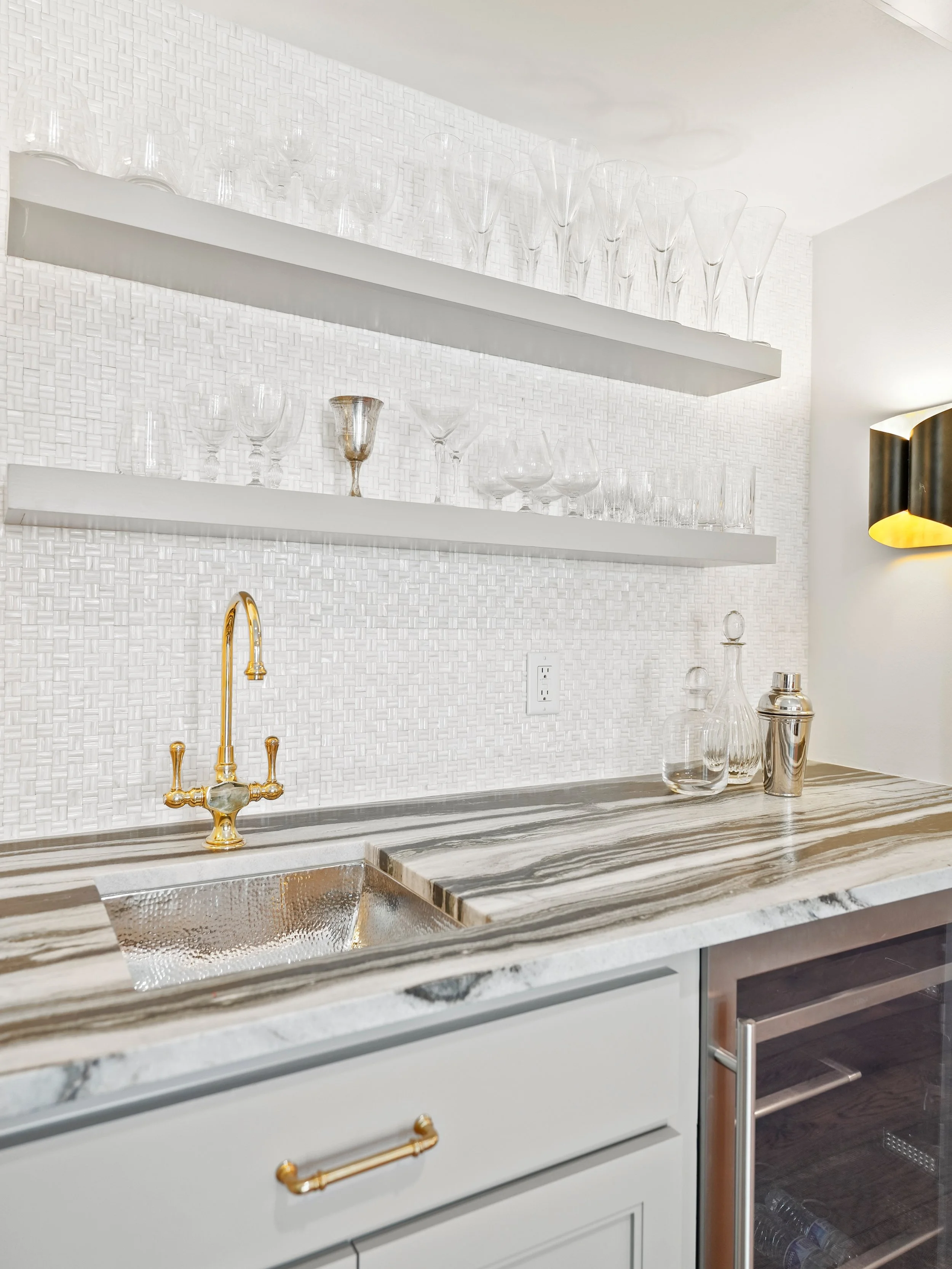 Happy hour starts early here🍸🍷 

Quite a transformation from the once dated wet bar in our clients&rsquo; home! We especially love the unique natural stone slab and the hammered bar sink. If you look close enough, you&rsquo;ll see the beautiful mot