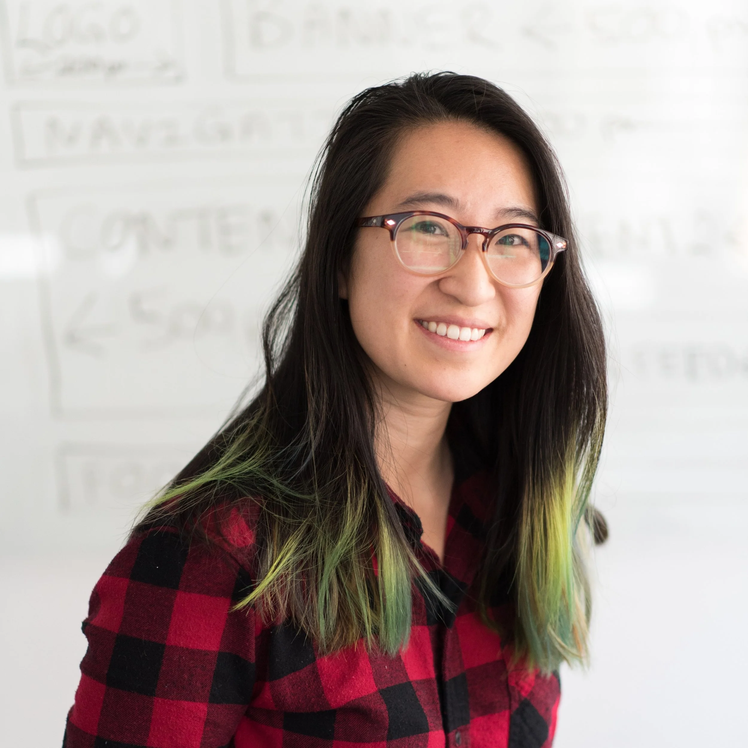 young woman wearing glasses smiling