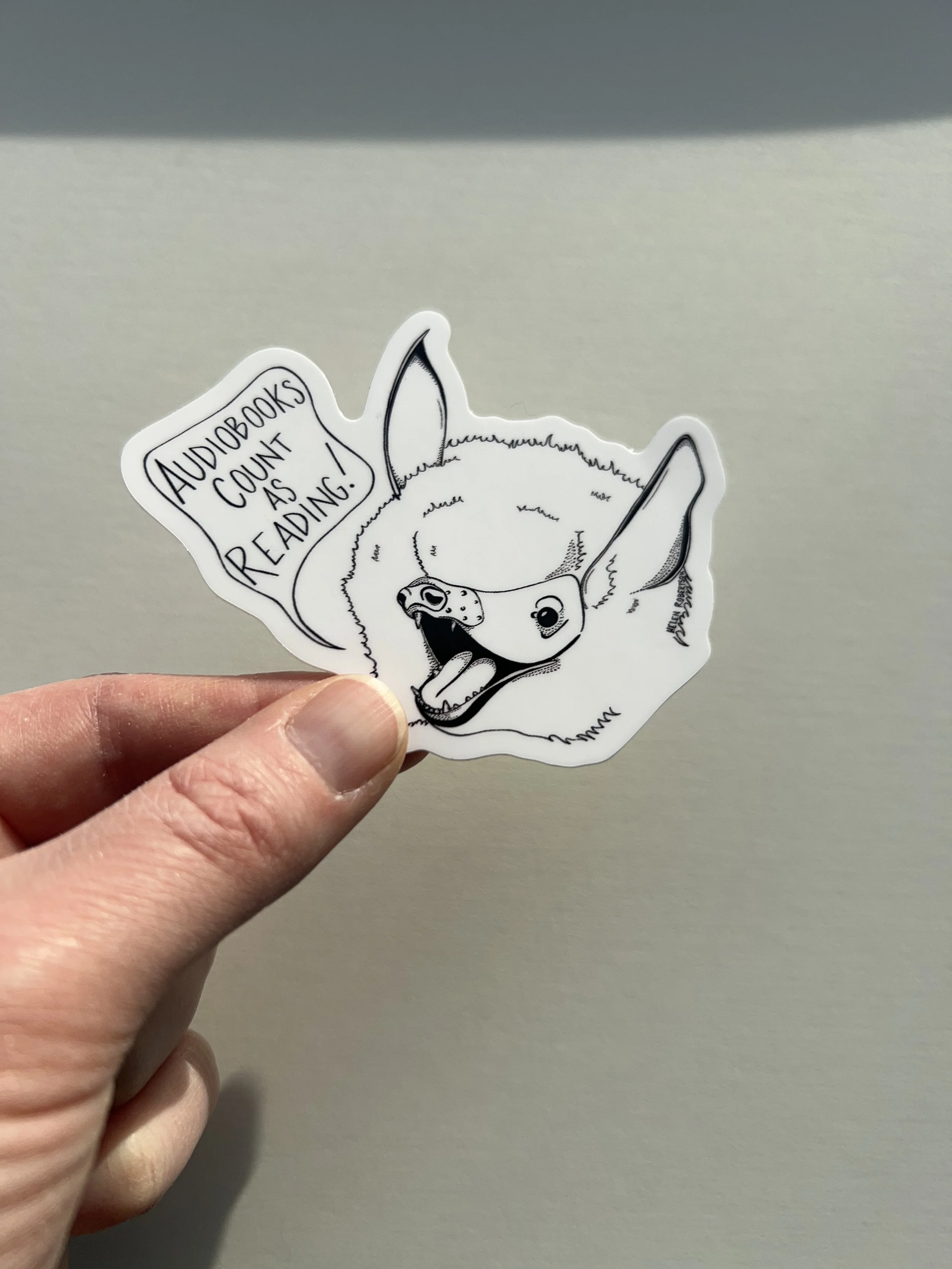 audiobook bat sticker in hand 2.JPG