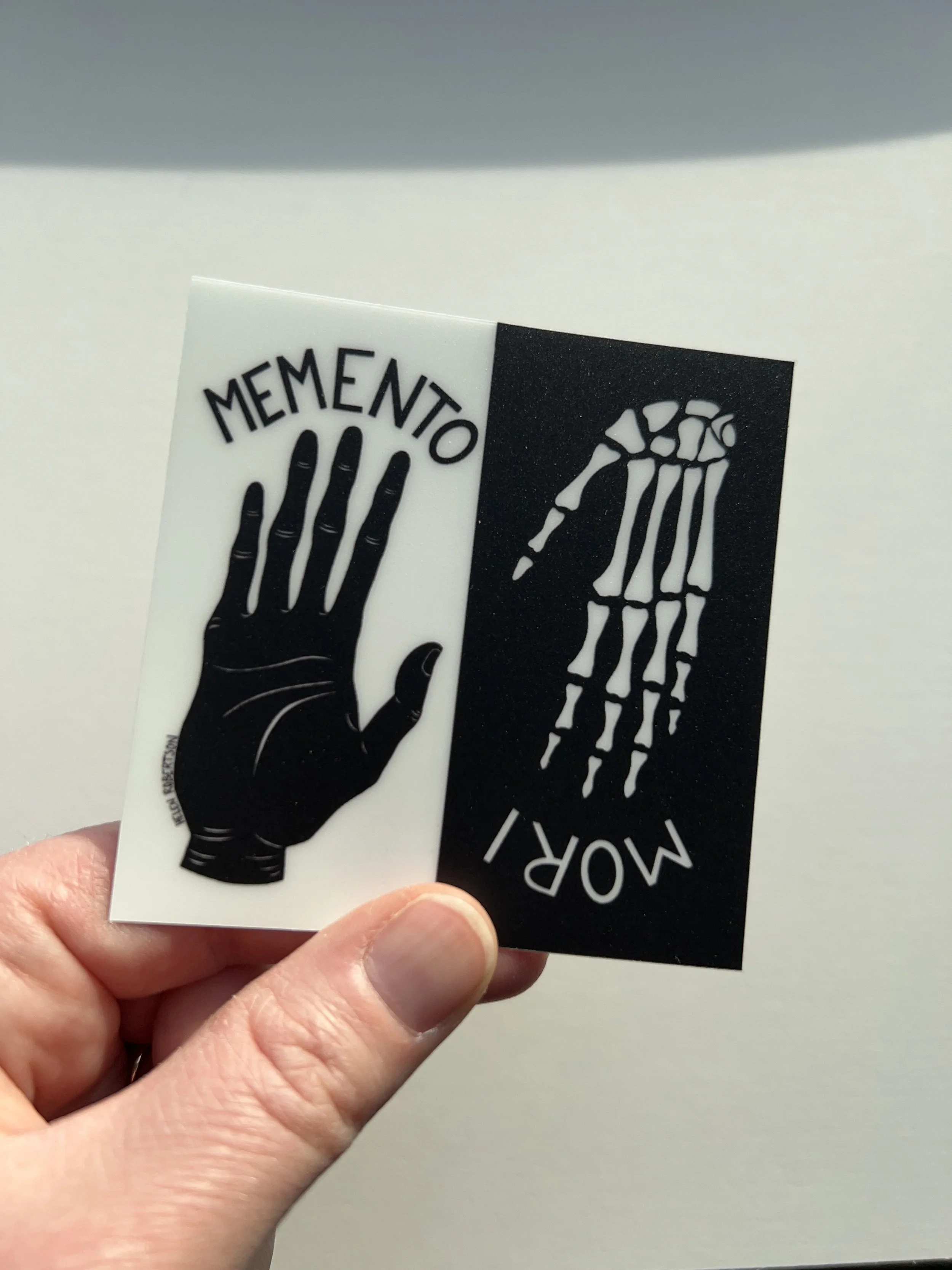 memento sticker in hand.JPG