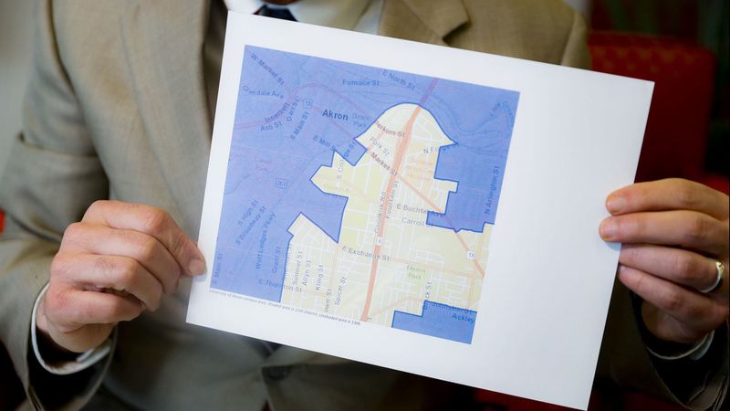 David Niven, a professor of political science at the University of Cincinnati, holds a map illustrating a gerrymandered Ohio district on April 11. (John Minchillo / Associated Press)