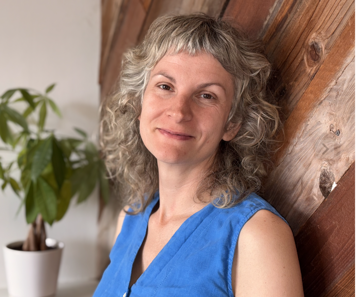 woman in a blue shirt smiling