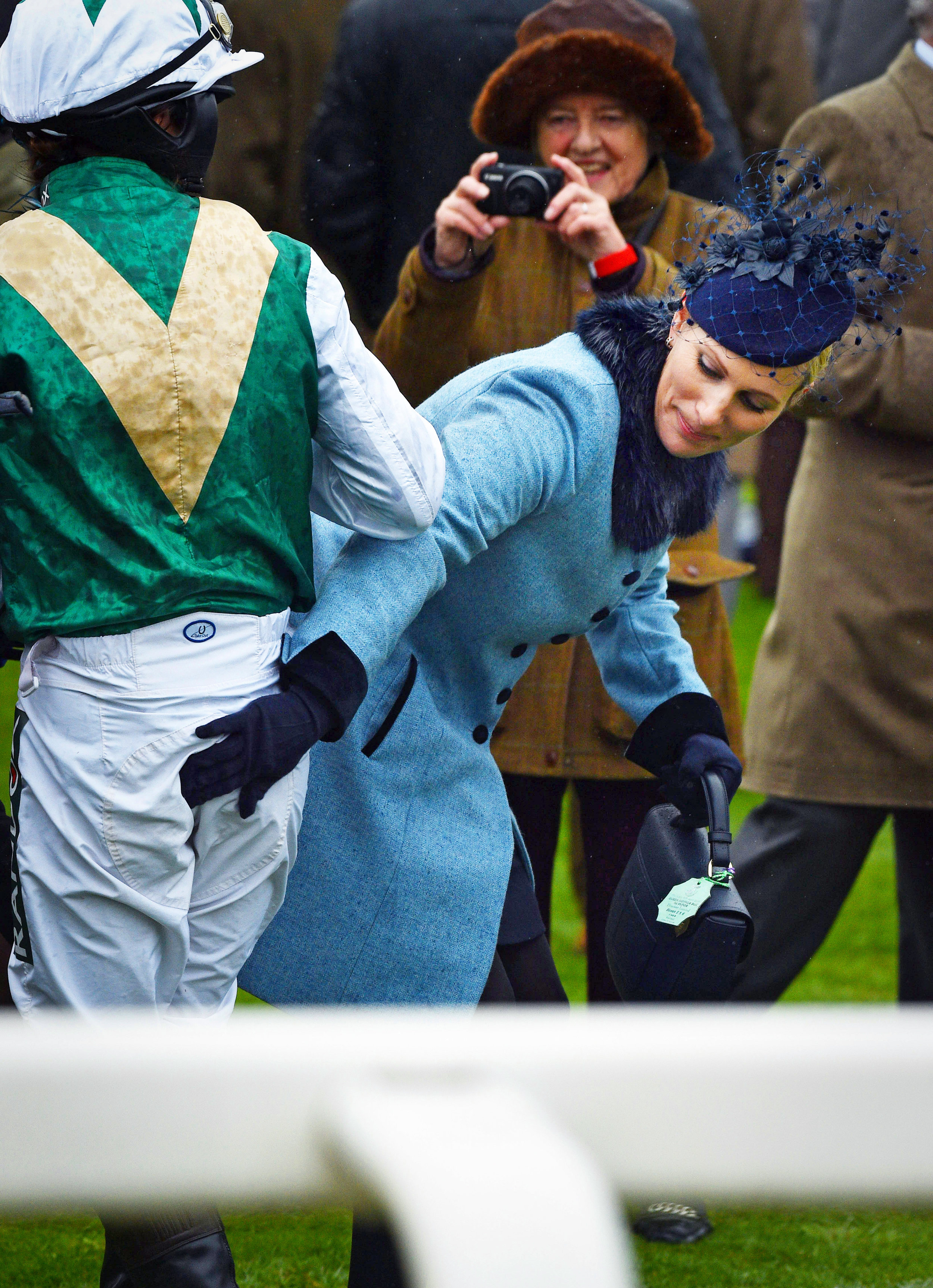  Zara Tindall pats the rear of a jockey in the Parade Ring before the Foxhunters Race during the Randox Grand National meeting at Aintree.

Photo by Bruce Adams, 04 April 2019
 